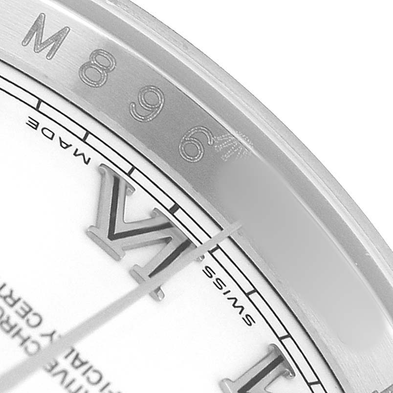 The image shows a close-up of the Rolex Datejust 116234 Men's Stainless Steel White Dial's watch dial, focusing on a Roman numeral and the surrounding bezel.