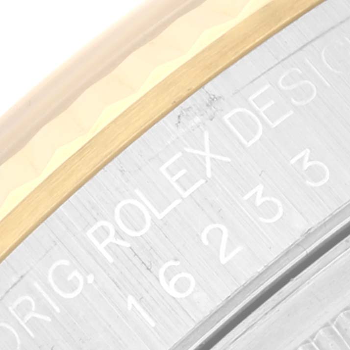 The image shows a close-up of the bezel and part of the case back of a Rolex Datejust 16233 Men's Steel and Gold (two tone) Black Dial 16233 Men's Steel and Gold (two tone) Black Dial watch.