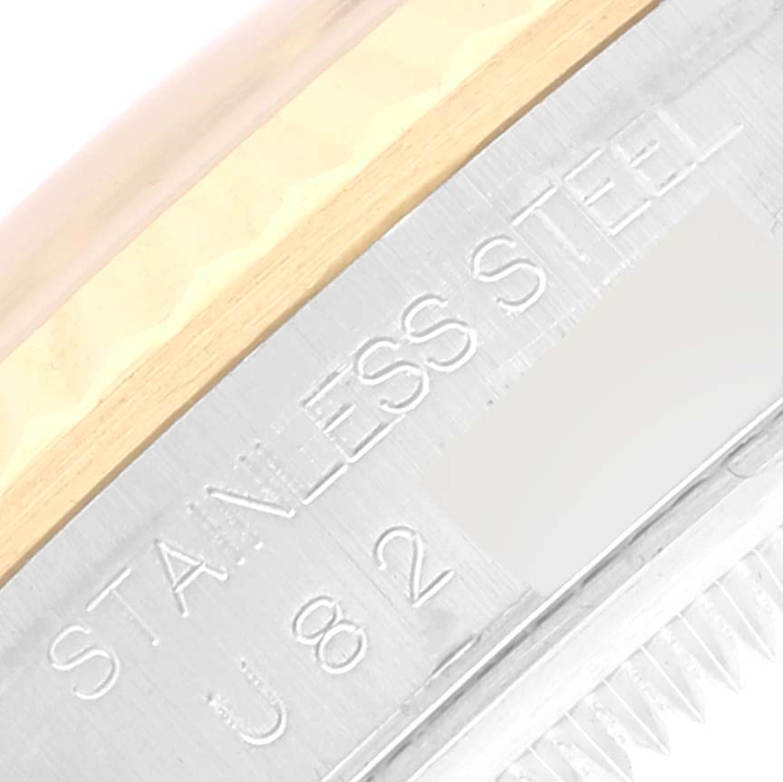 The image shows a close-up view of the stainless steel and gold bezel of a Rolex Datejust 16233 Men's Steel and Gold (two tone) Black Dial 16233 Men's Steel and Gold (two tone) Black Dial watch.