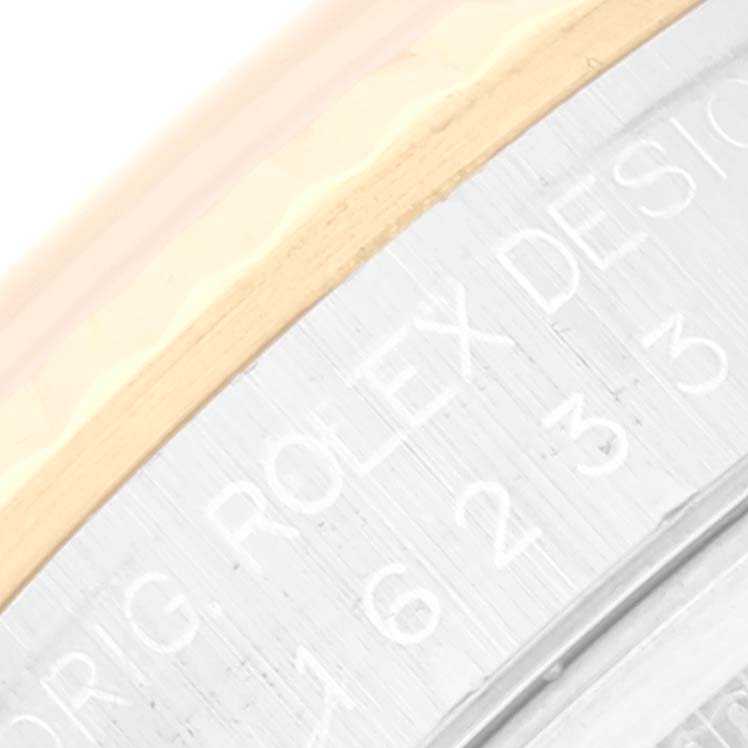 The image shows a close-up angle of the edge of the case and bezel, highlighting the engravings on the Rolex Datejust 16233 Men's Steel and Gold (two tone) Black Dial 16233 Men's Steel and Gold (two tone) Black Dial model.