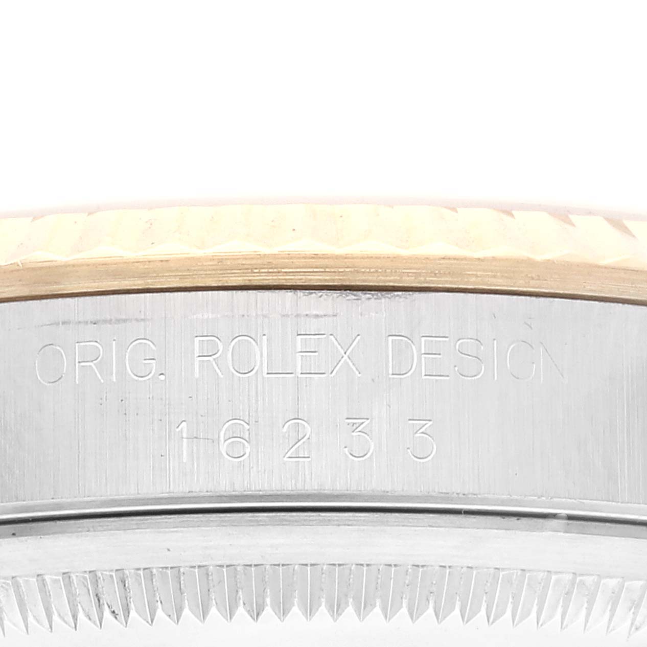 This image shows a close-up of the side edge of a Rolex Datejust 16233 Men's Steel and Gold (two tone) Champagne Dial 16233 Men's Steel and Gold (two tone) Champagne Dial watch, highlighting the "ORIG. ROLEX DESIGN" engraving and model number 16233.
