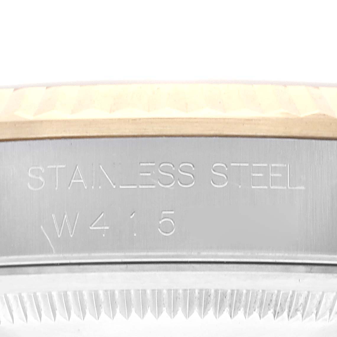 The image shows a close-up of the stainless steel case side of a Rolex Datejust 16233 Men's Steel and Gold (two tone) Champagne Dial 16233 Men's Steel and Gold (two tone) Champagne Dial watch, with part of the fluted bezel visible.