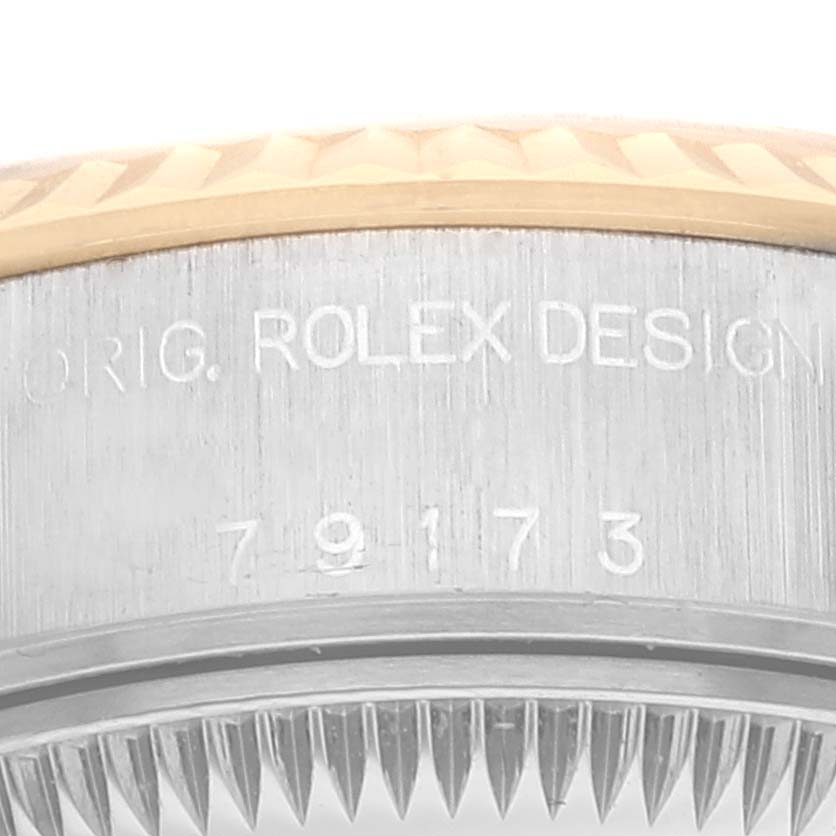 The image shows a close-up of the side of a Rolex Datejust 79173 Women's Steel and Gold (two tone) Champagne Dial 79173 Women's Steel and Gold (two tone) Champagne Dial watch case, highlighting the serial number engraved on it.