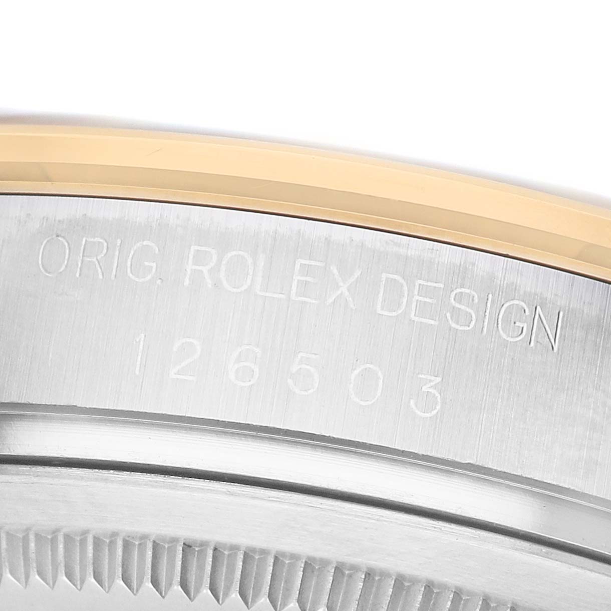 The image shows a close-up of the engraved edge of a Rolex Daytona 126503 Men's Steel and Gold (two tone) Black Dial, highlighting the model number and design details.