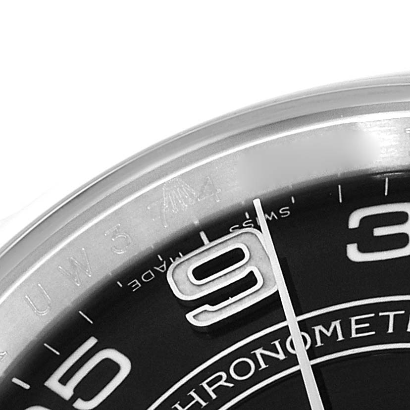 The image shows a close-up of the dial and bezel of a Rolex Oyster Perpetual 116000 Men's Stainless Steel Black Dial 116000 Men's Stainless Steel Black Dial watch, highlighting the numbers 3 and 9.