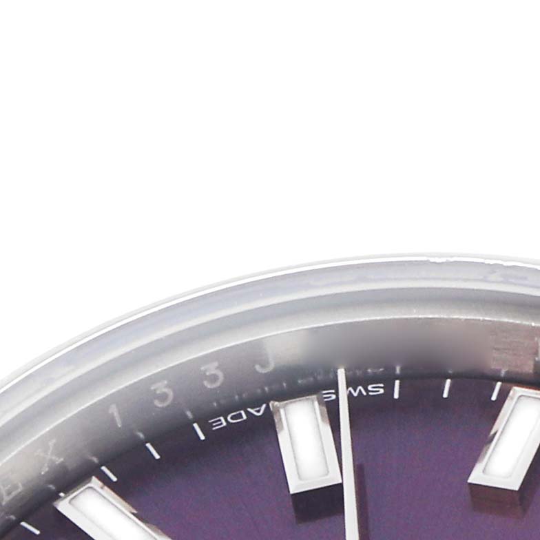 This image shows a partial view of the dial and bezel of a Rolex Oyster Perpetual 176200 Women
s Stainless Steel Purple Dial 176200 Women
s Stainless Steel Purple Dial watch from a close-up angle.