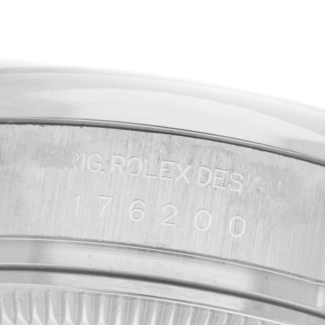 The image shows a close-up of the serial number and engraving on the side of a Rolex Oyster Perpetual 176200 Women
s Stainless Steel Purple Dial 176200 Women
s Stainless Steel Purple Dial watch case.