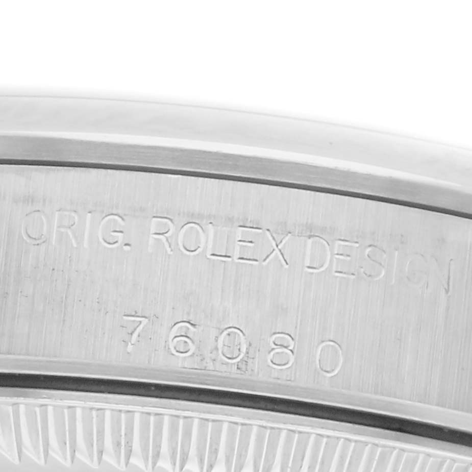 The image shows the engraved side of a Rolex Oyster Perpetual 76080 Women's Stainless Steel Silver Dial 76080 Women's Stainless Steel Silver Dial, highlighting the "Orig. Rolex Design 76080."