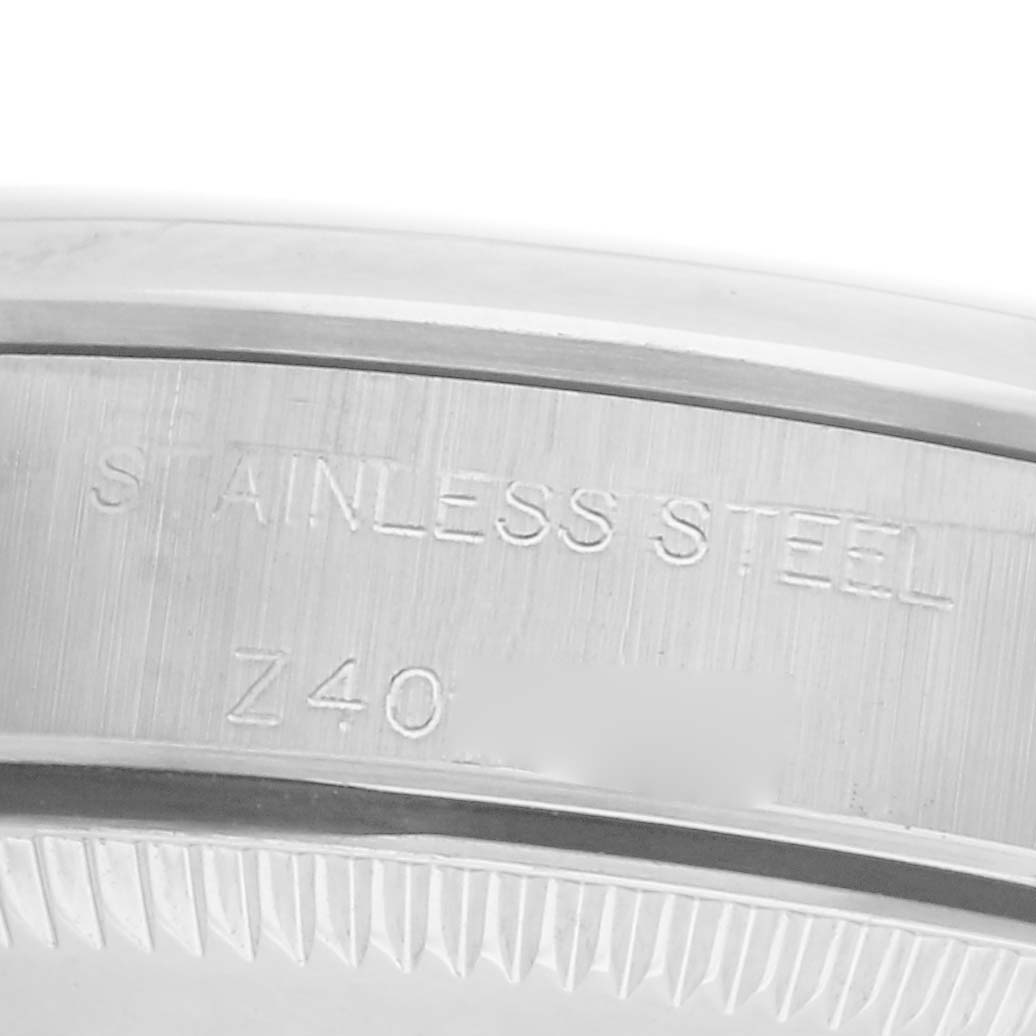 The image shows a close-up of the case back's edge of a Rolex Oyster Perpetual 76080 Women's Stainless Steel Silver Dial 76080 Women's Stainless Steel Silver Dial, highlighting "STAINLESS STEEL" engraving.