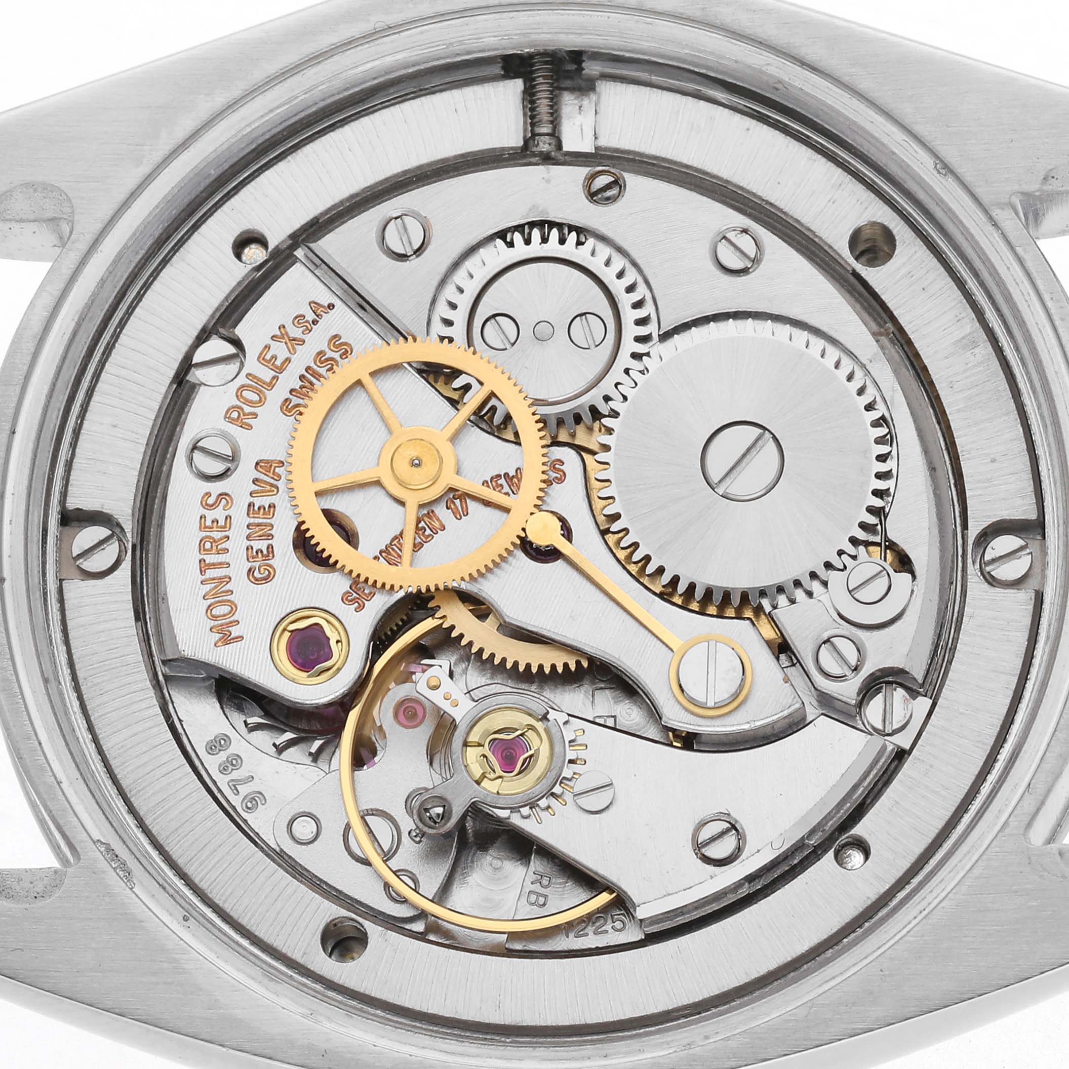 The image shows the intricate inner mechanisms of a Rolex Vintage Collection 6694 Men
s Stainless Steel Silver Dial 6694 Men
s Stainless Steel Silver Dial watch, highlighting gears and movement parts.