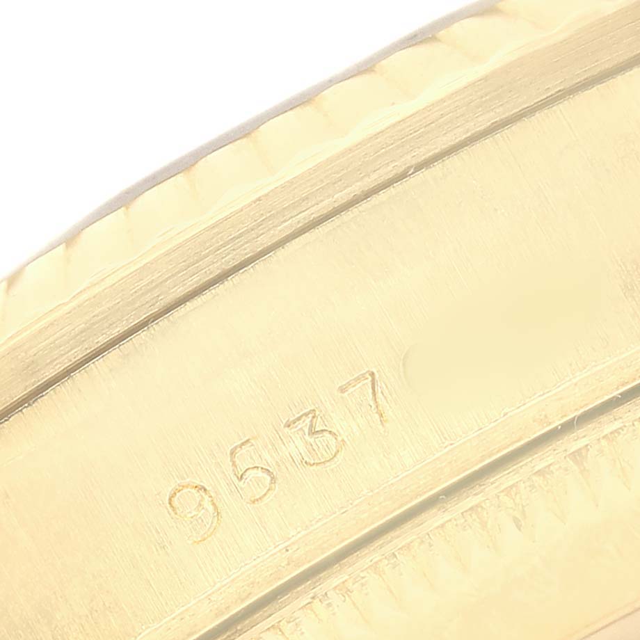 The image shows a close-up of the side of a Rolex President 68278 Women's Yellow Gold Blue Dial model with visible engravings.