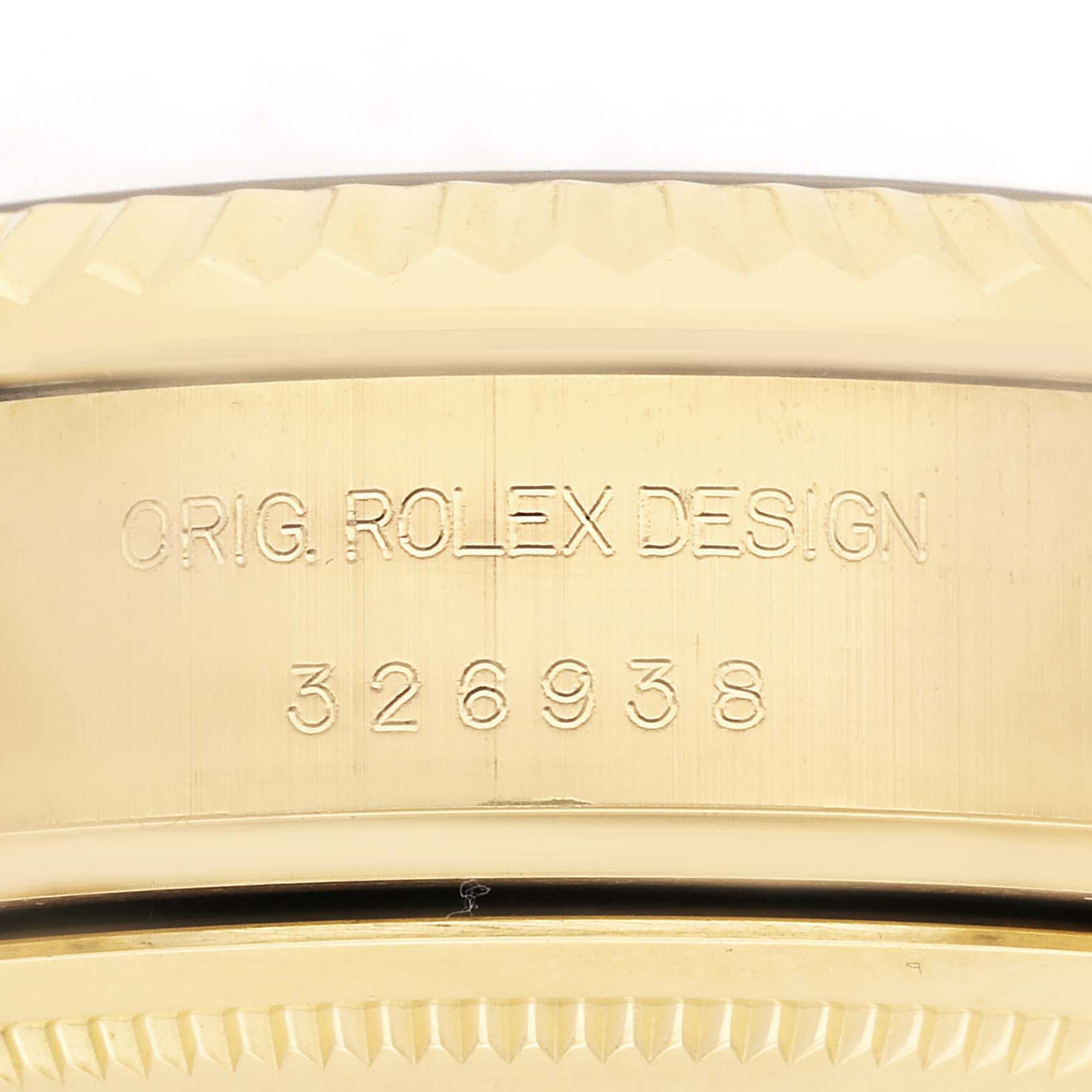 The image shows a close-up of the case side, focusing on the engraving "ORIG. ROLEX DESIGN 326938" of a Rolex Sky-Dweller 326938 Men
s Yellow Gold Silver Dial 326938 Men
s Yellow Gold Silver Dial.