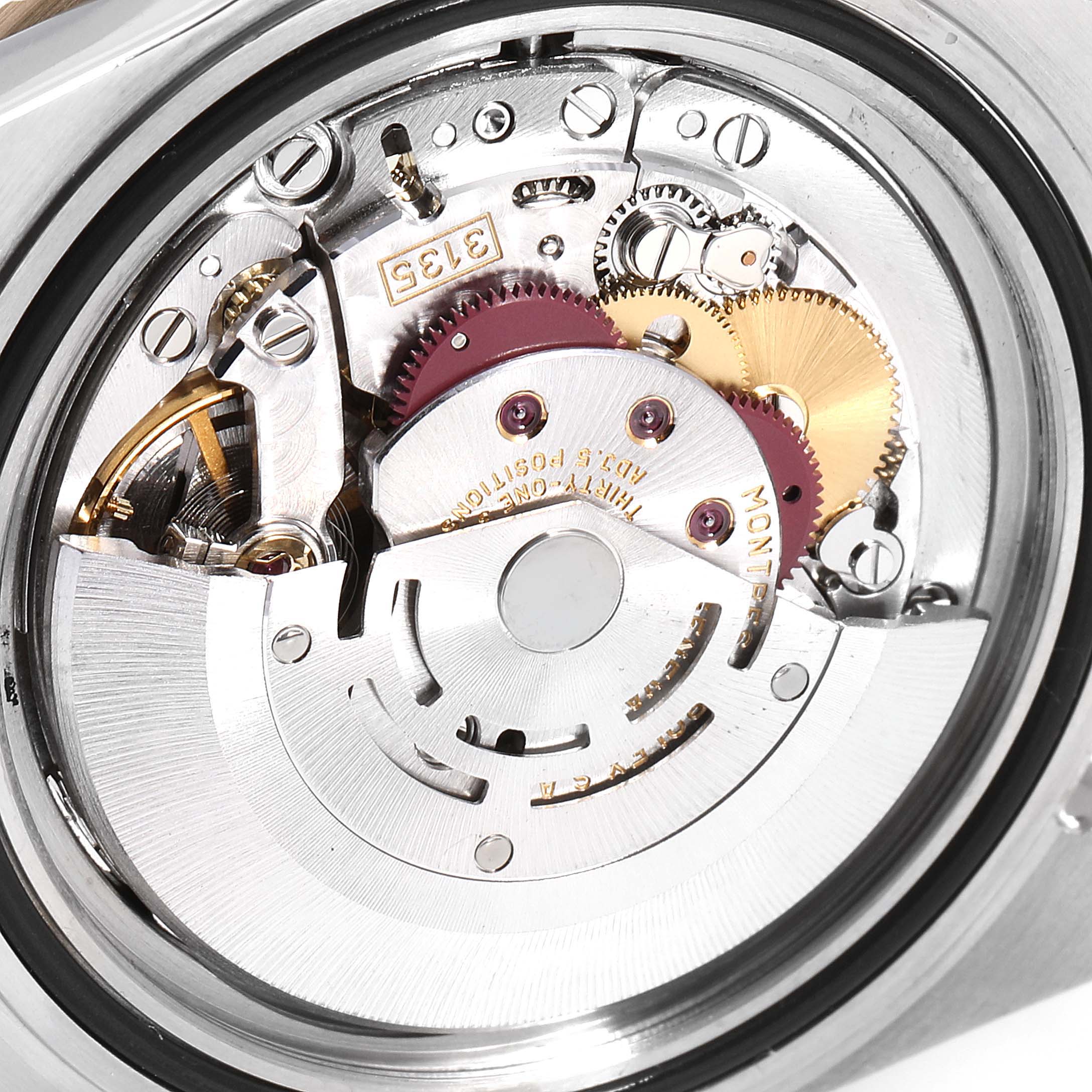 The image shows the internal mechanism of a Rolex Submariner 16613 Men
s Steel and Gold (two tone) Blue Dial 16613 Men
s Steel and Gold (two tone) Blue Dial watch, focusing on its intricate gears and movement parts from a top-down angle.