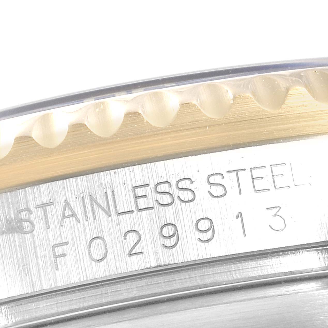 The image shows a close-up angle of the bezel and engraved serial number on the case of a Rolex Submariner 16613 Men
s Steel and Gold (two tone) Blue Dial 16613 Men
s Steel and Gold (two tone) Blue Dial.