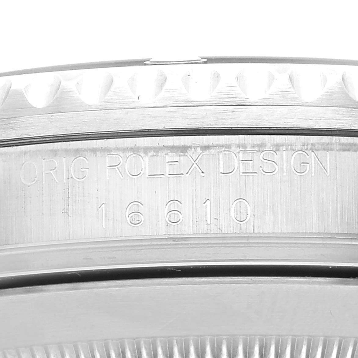 The image shows a close-up of the case side of a Rolex Submariner 16610 Men
s Stainless Steel Black Dial 16610 Men
s Stainless Steel Black Dial, displaying the model number and "ORIG ROLEX DESIGN" engraving.