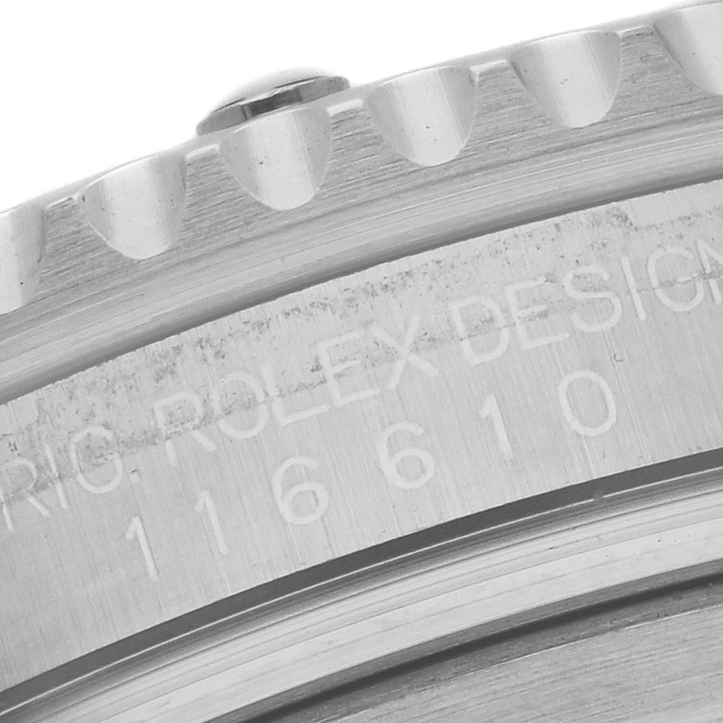This image shows a close-up of the engraved bezel and edge of the case of a Rolex Submariner 116610 Men
s Stainless Steel Black Dial 116610 Men
s Stainless Steel Black Dial watch.