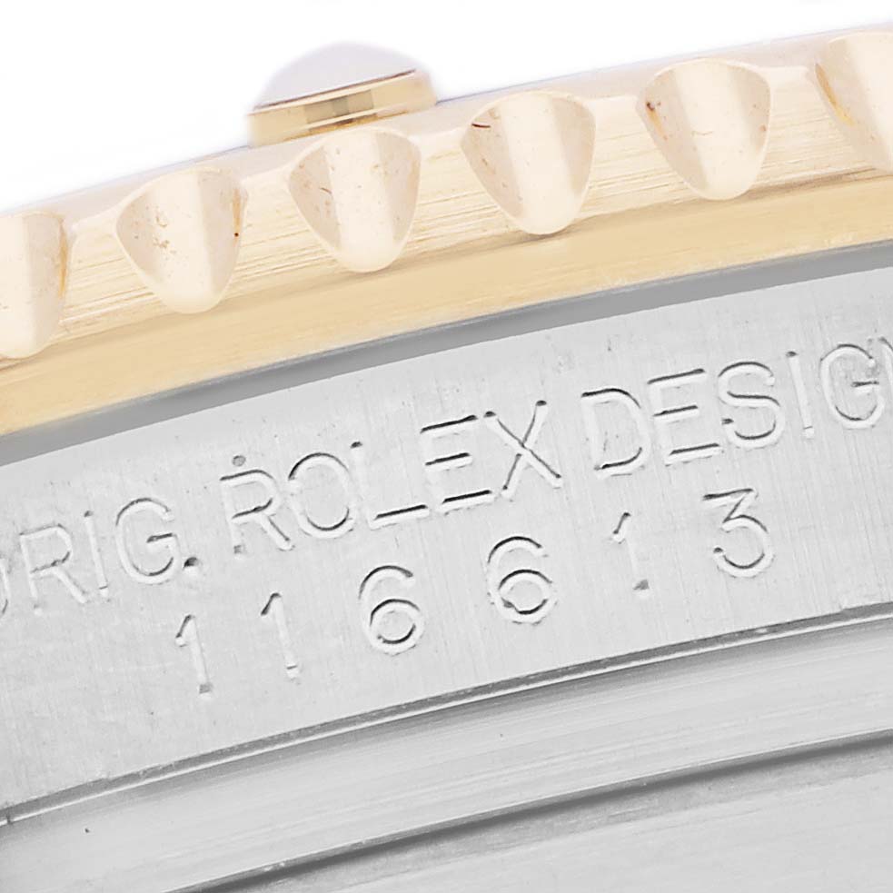 The image shows a close-up of the Rolex Submariner 116613 Men's Steel and Gold (two tone) Black Dial 116613 Men's Steel and Gold (two tone) Black Dial's case back, highlighting the engraving and part of the bezel.