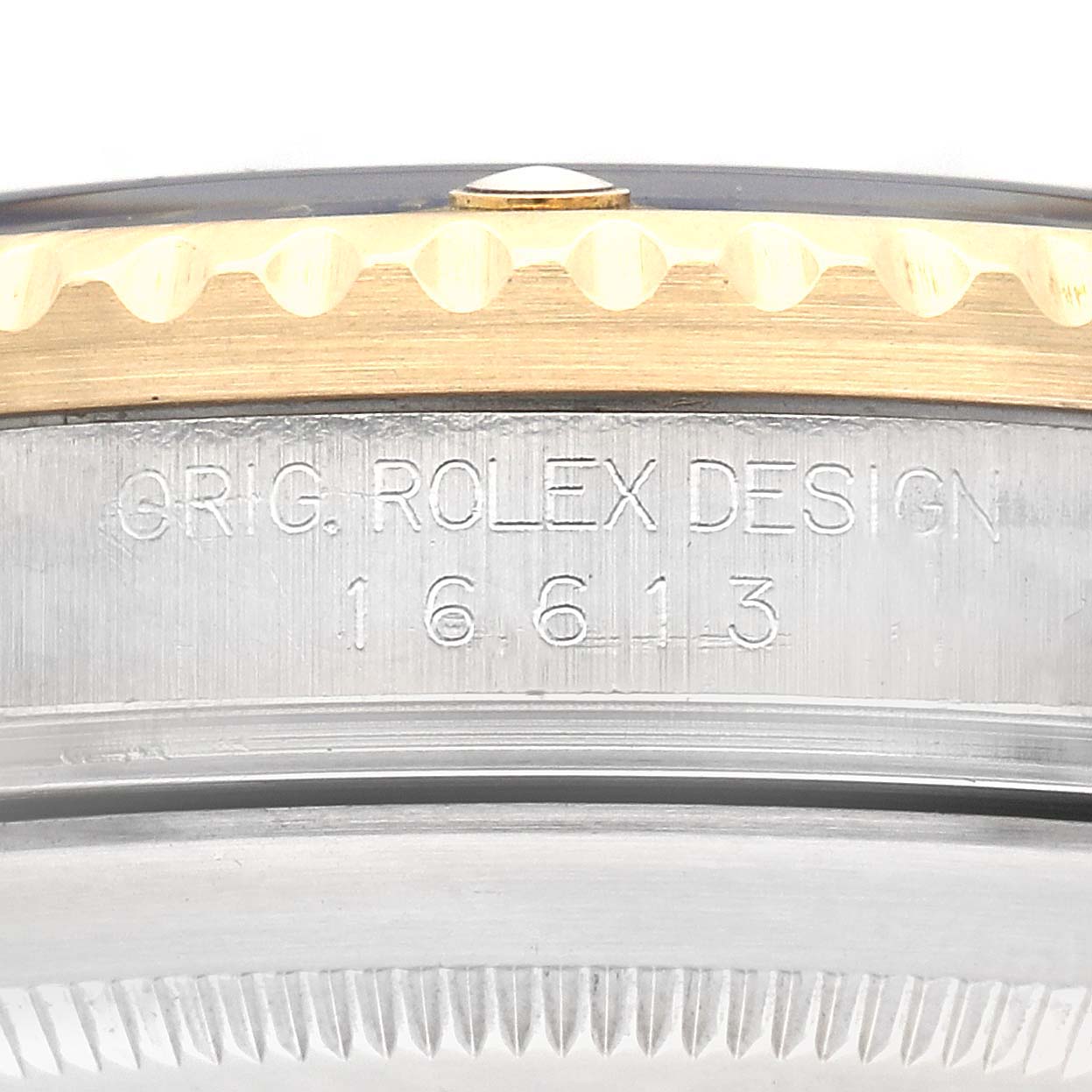 The image shows a close-up of the side engraving and bezel edge of a Rolex Submariner 16613 Men's Steel and Gold (two tone) Blue Dial 16613 Men's Steel and Gold (two tone) Blue Dial watch, model number 16613.