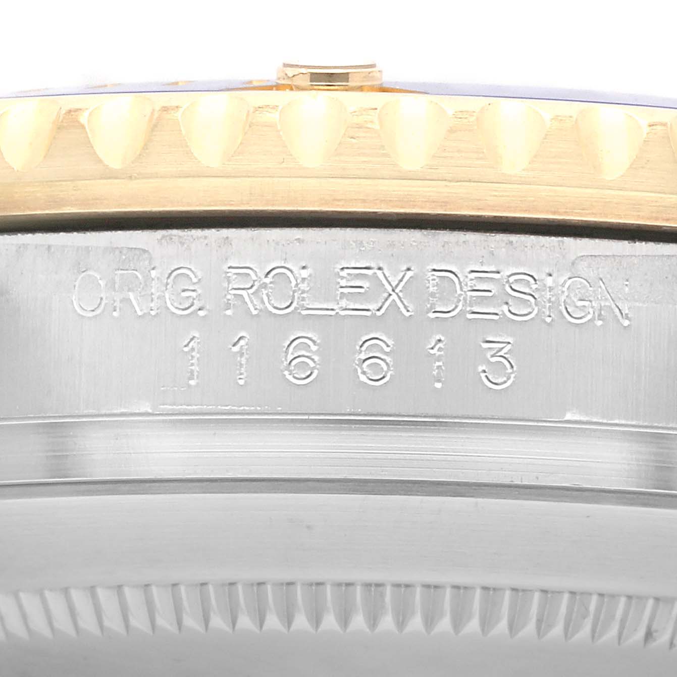 The image shows the side view of a Rolex Submariner 116613 Men's Steel and Gold (two tone) Blue Dial 116613 Men's Steel and Gold (two tone) Blue Dial, highlighting the engraved model number and bezel edge.