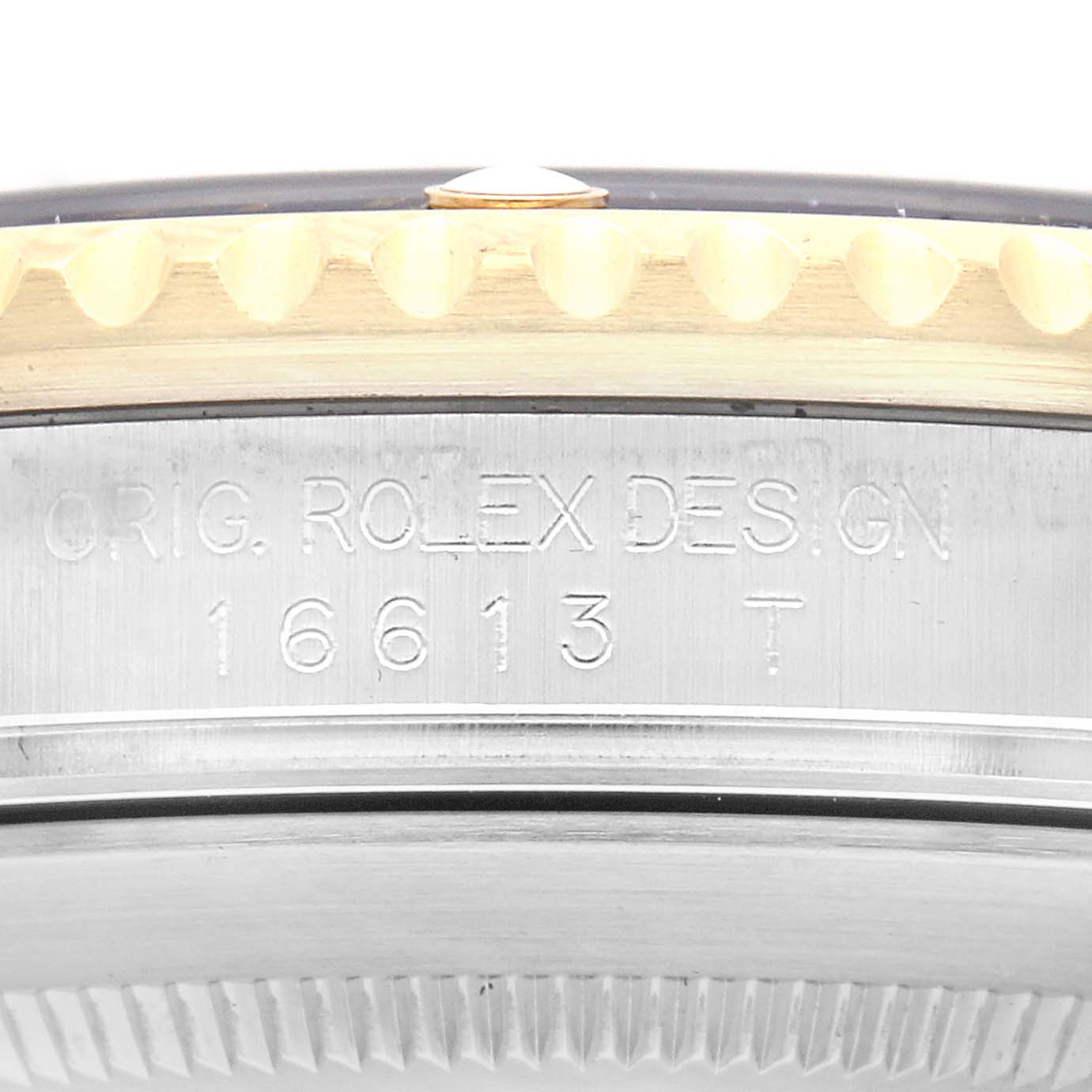 The image shows a close-up side view of the Rolex Submariner 16613 Men
s Steel and Gold (two tone) Blue Dial 16613 Men
s Steel and Gold (two tone) Blue Dial, highlighting its engraved model number and design details on the case.