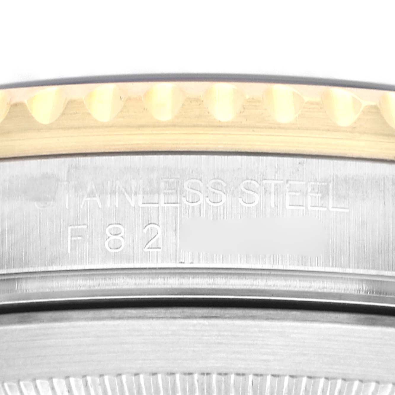 The image shows a close-up of the bezel and the engraved side of the Rolex Submariner 16613 Men
s Steel and Gold (two tone) Blue Dial 16613 Men
s Steel and Gold (two tone) Blue Dial watch case.