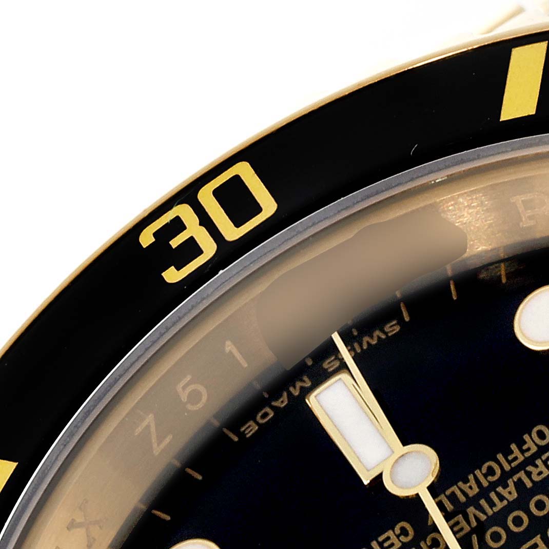 This close-up image of the Rolex Submariner 16618 Men's Yellow Gold Black Dial 16618 Men's Yellow Gold Black Dial watch shows the bezel with the "30" marker and part of the dial and hands.