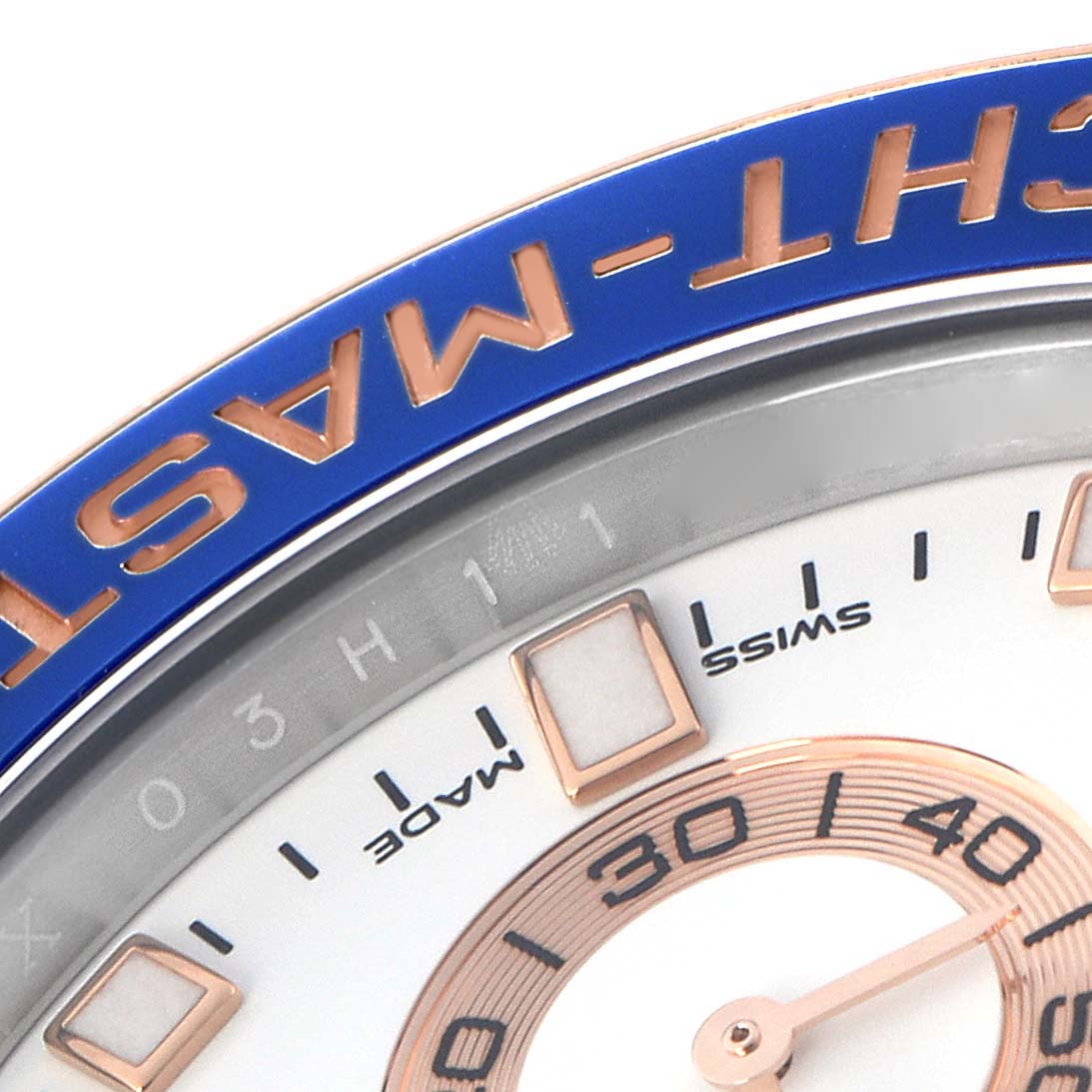 The image shows a close-up angle of the Rolex Yacht-Master 116681 Men
s Steel and Gold (two tone) White Dial 116681 Men
s Steel and Gold (two tone) White Dial
s bezel and a portion of the dial with hour markers.