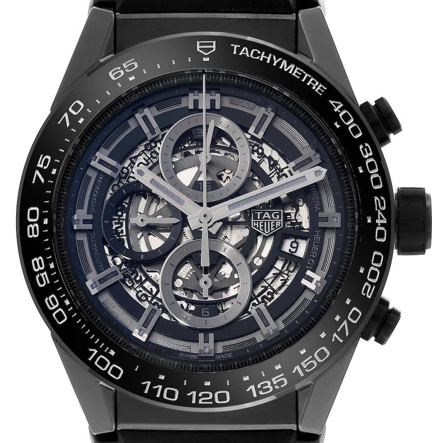 The image shows a front view of a Tag Heuer Carrera watch displaying the tachymeter scale and chronograph sub-dials.