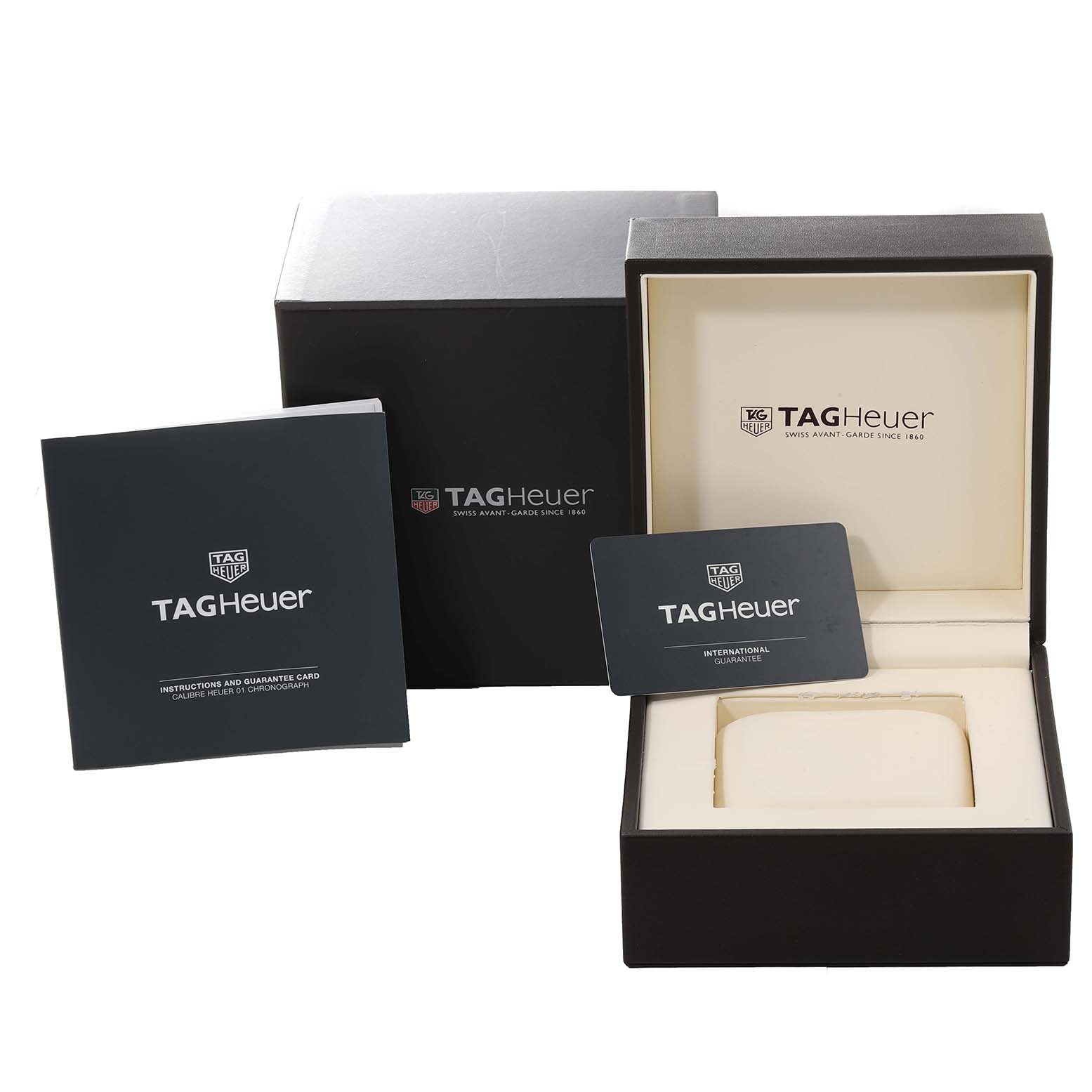 The image shows the packaging and accessories for a Carrera model by Tag Heuer, including the outer box, watch box, guarantee card, and instruction booklet.