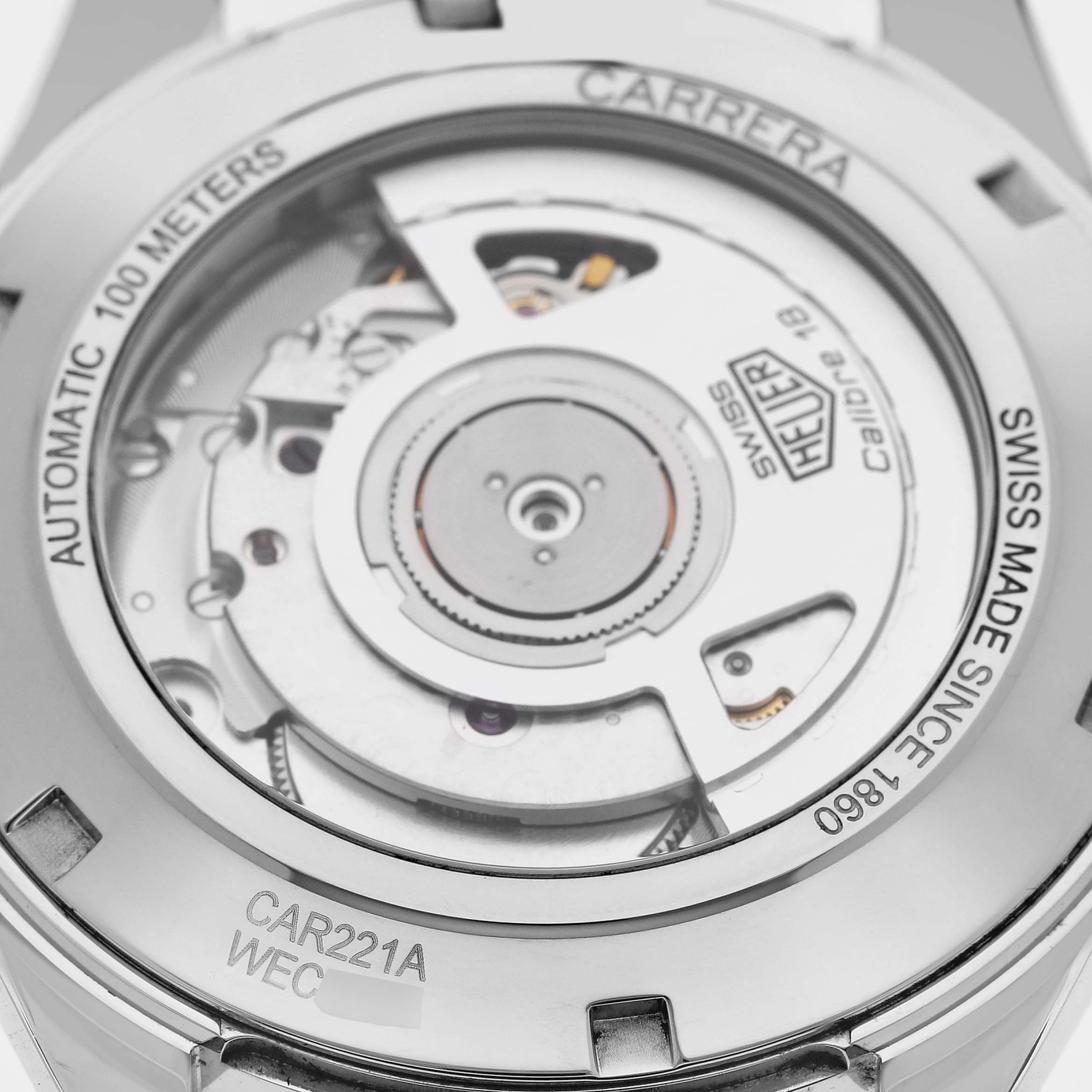 The image shows the back of the Tag Heuer Carrera CAR221A Men's Stainless Steel Silver Dial CAR221A Men's Stainless Steel Silver Dial watch, highlighting its Calibre 18 movement and "Swiss Made" inscription.