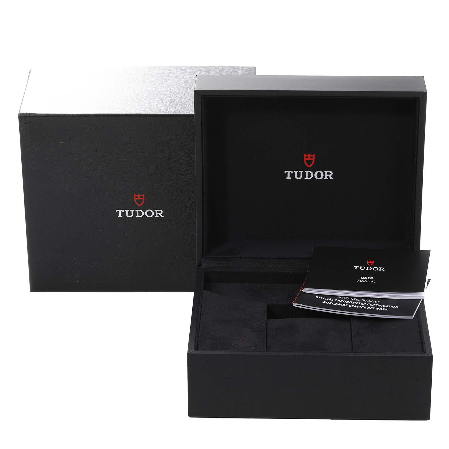 The image shows the open box and user manual for the Tudor Heritage Black Bay 79230R Men
s Stainless Steel Black Dial 79230R Men
s Stainless Steel Black Dial watch from a slightly elevated front angle.
