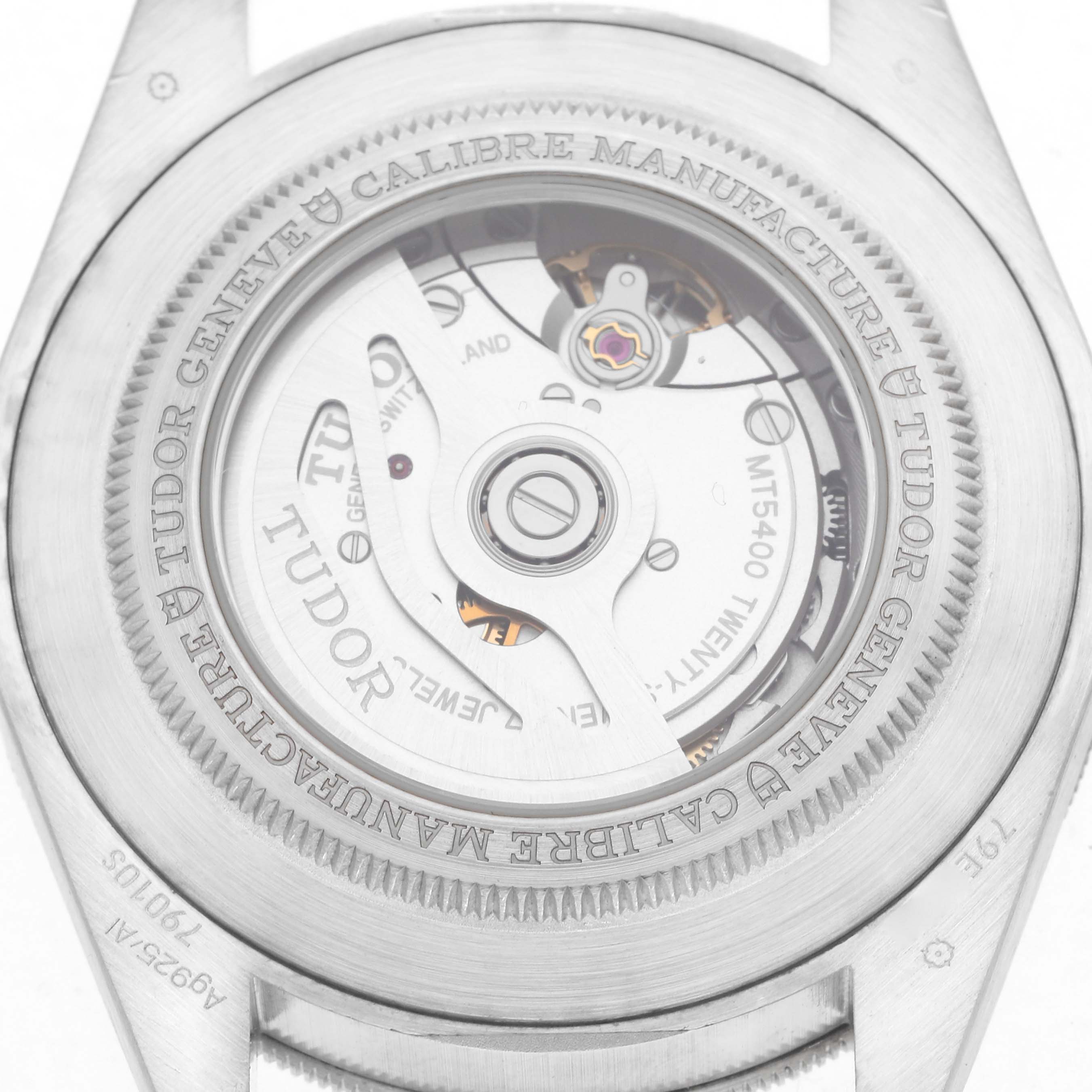 The image shows the back of the Tudor Heritage Black Bay 79010 Men
s Stainless Steel Grey Dial 79010 Men
s Stainless Steel Grey Dial watch, highlighting its internal movement and engravings.
