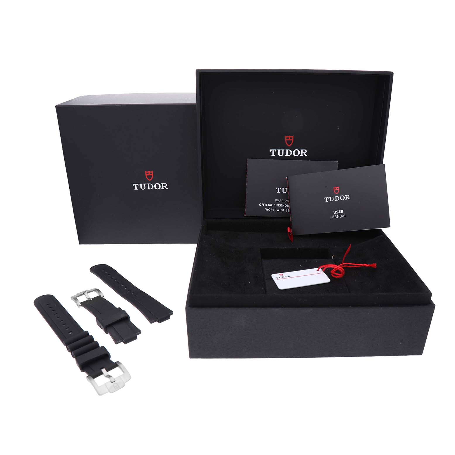The image shows the packaging and accessories for the Tudor Pelagos M25407N Men's Titanium Black Dial model, including the box, user manual, and extra straps.