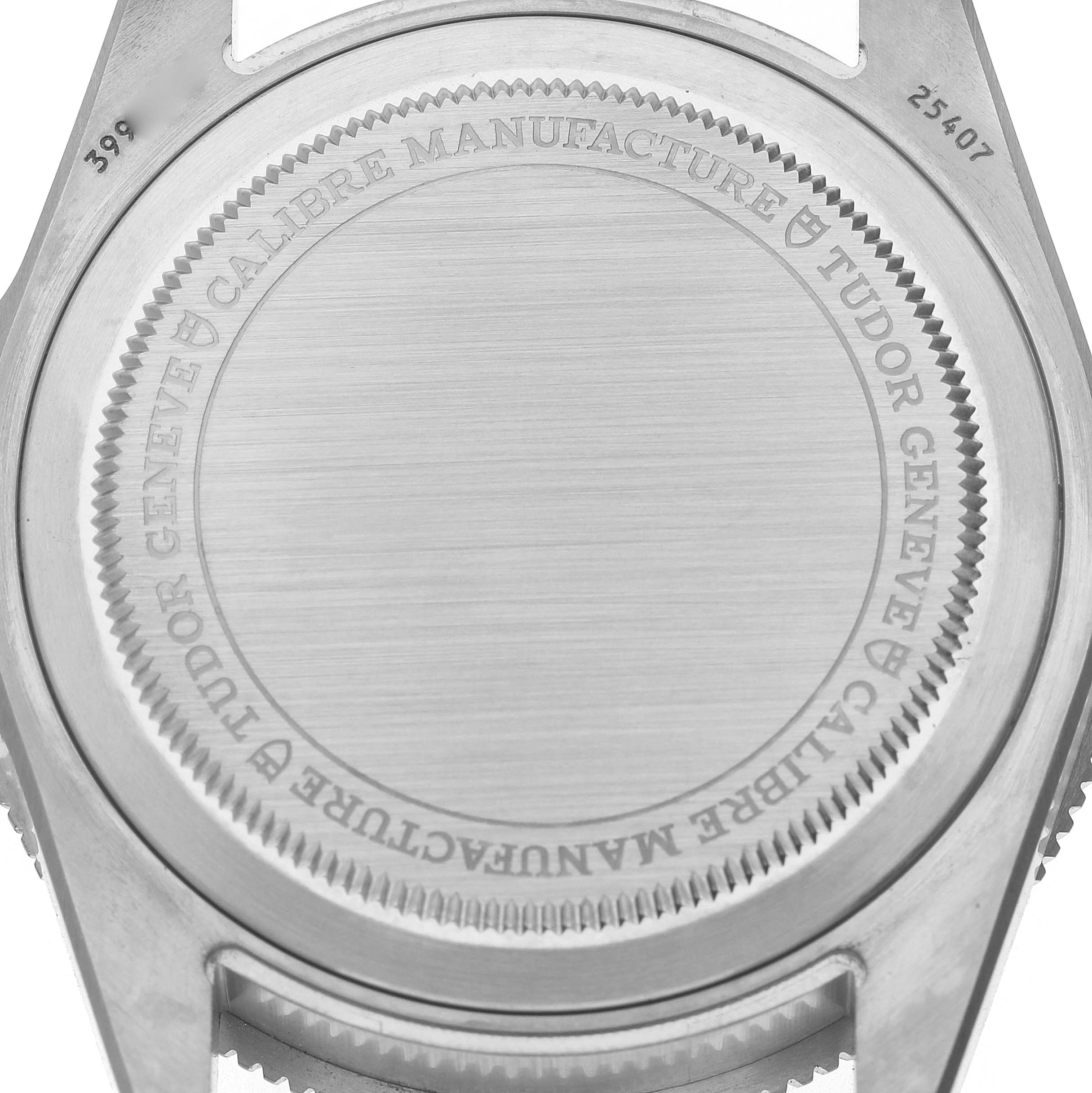 The image shows the back casing of a Tudor Pelagos M25407N Men's Titanium Black Dial watch, highlighting its engraved details and brushed finish.
