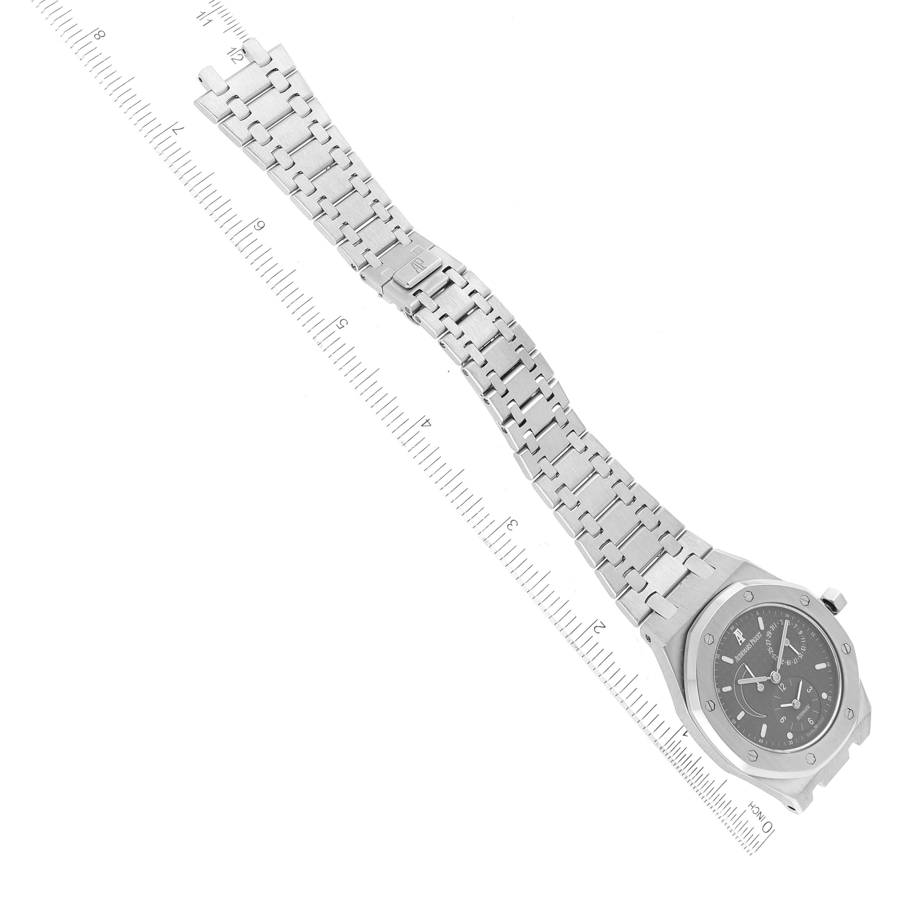 The image shows the Audemars Piguet Royal Oak 25730ST Men's Stainless Steel Black Dial 25730ST Men's Stainless Steel Black Dial watch laid flat with its bracelet fully extended and a ruler for scale.