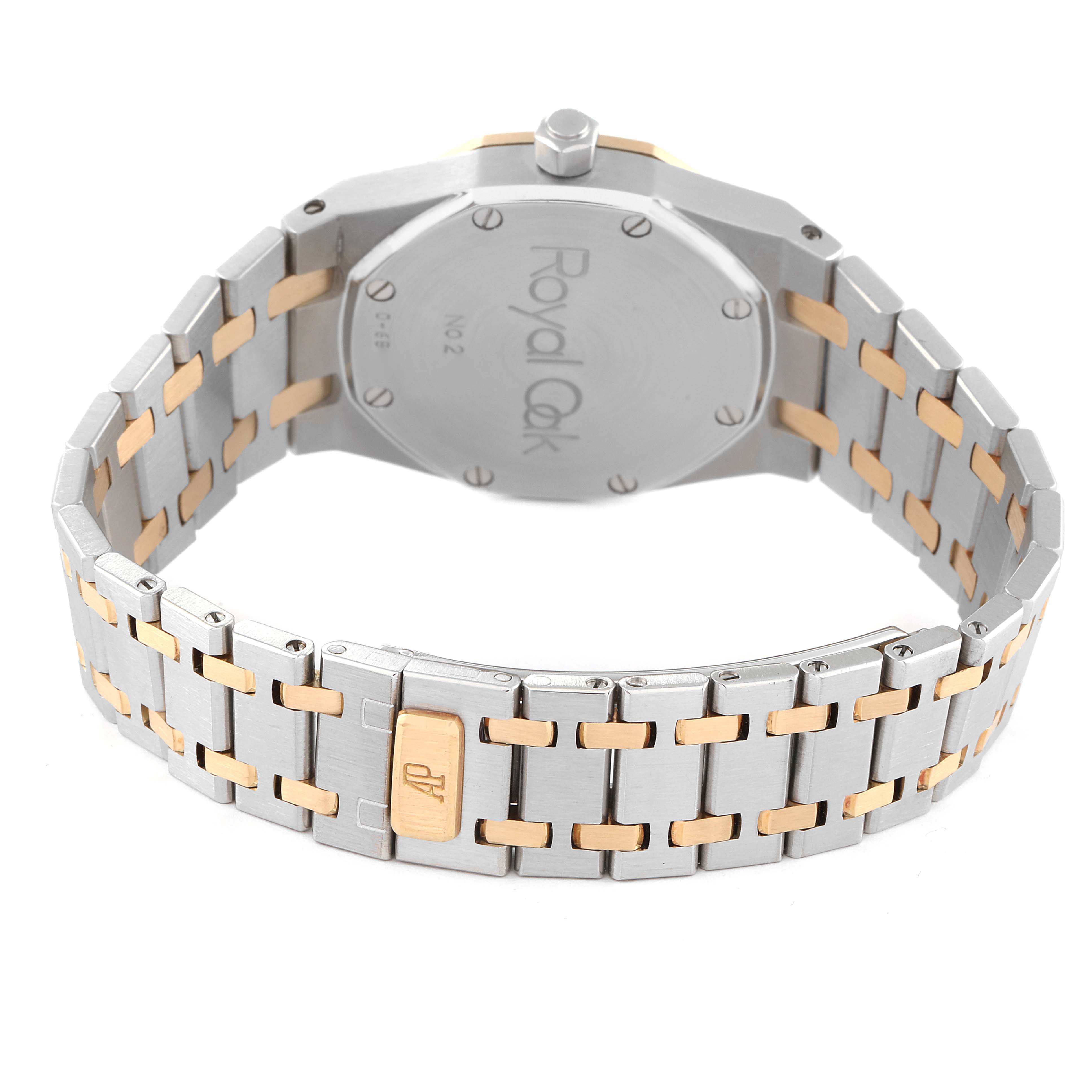 The image shows the back case and bracelet of an Audemars Piguet Royal Oak 15000SA-O-0789SA Men's Steel and Gold (two tone) Champagne Dial 15000SA-O-0789SA Men's Steel and Gold (two tone) Champagne Dial watch, with a focus on the logo and clasp.