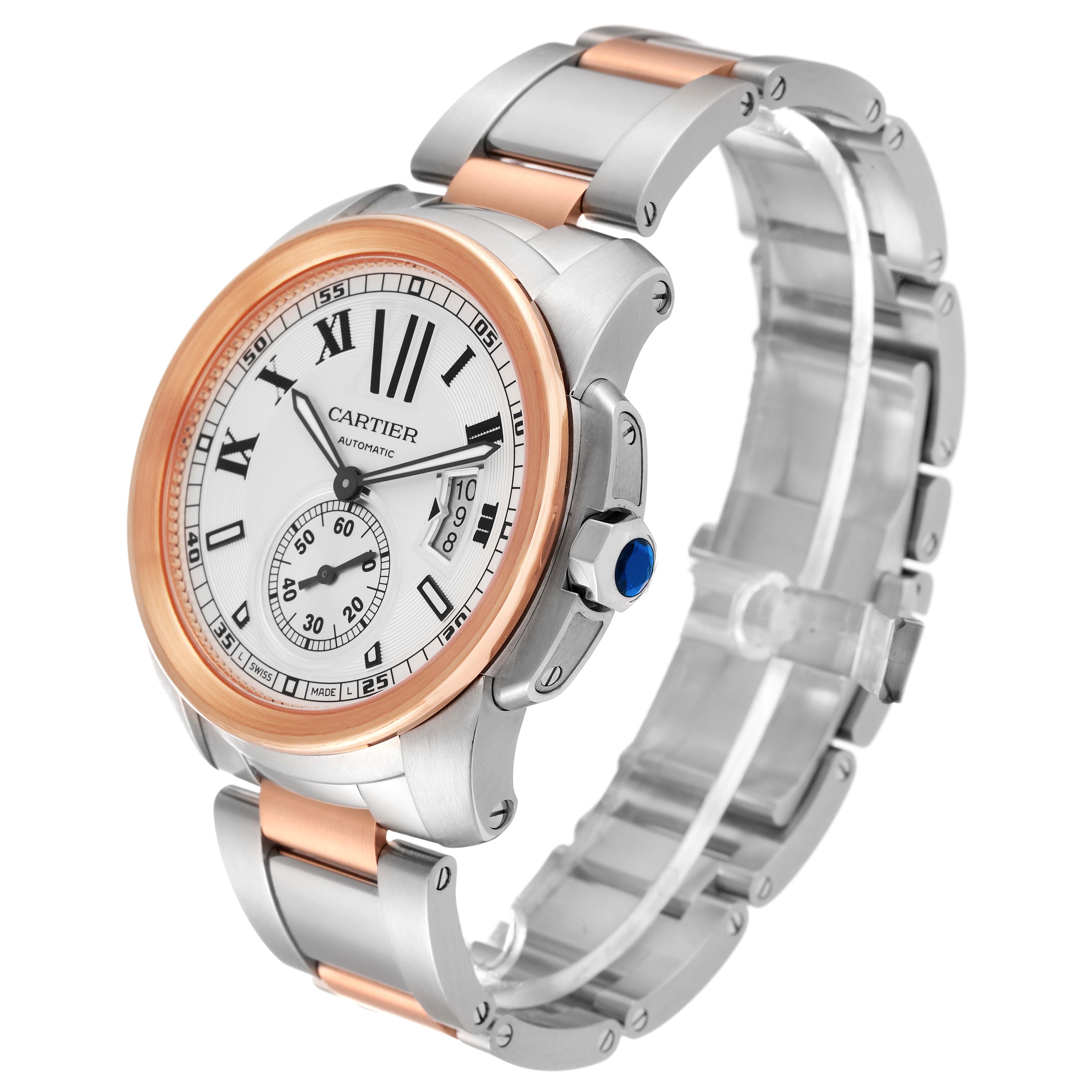 The image shows a Calibre de Cartier watch by Cartier at a three-quarter angle, highlighting its face, bezel, crown, and bracelet.