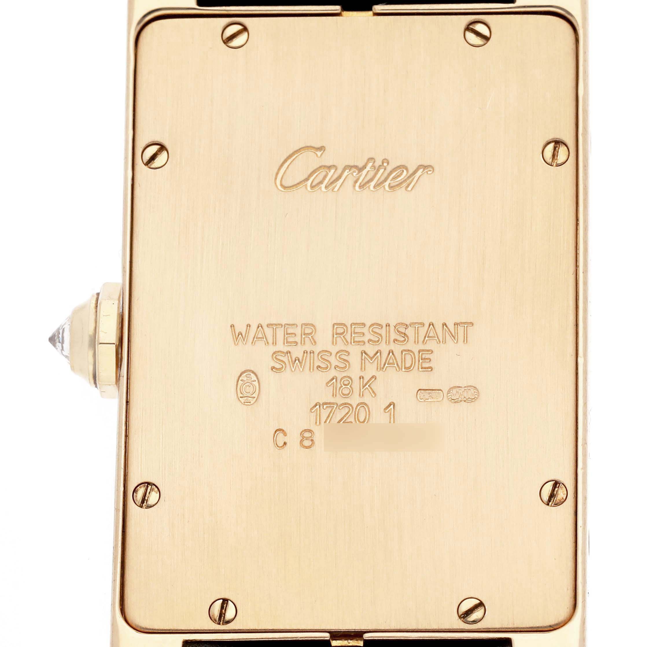 The image shows the back of a Cartier Tank Americaine 17201 Men
s Yellow Gold Silver Dial 17201 Men
s Yellow Gold Silver Dial watch, highlighting its gold case and water resistance markings.