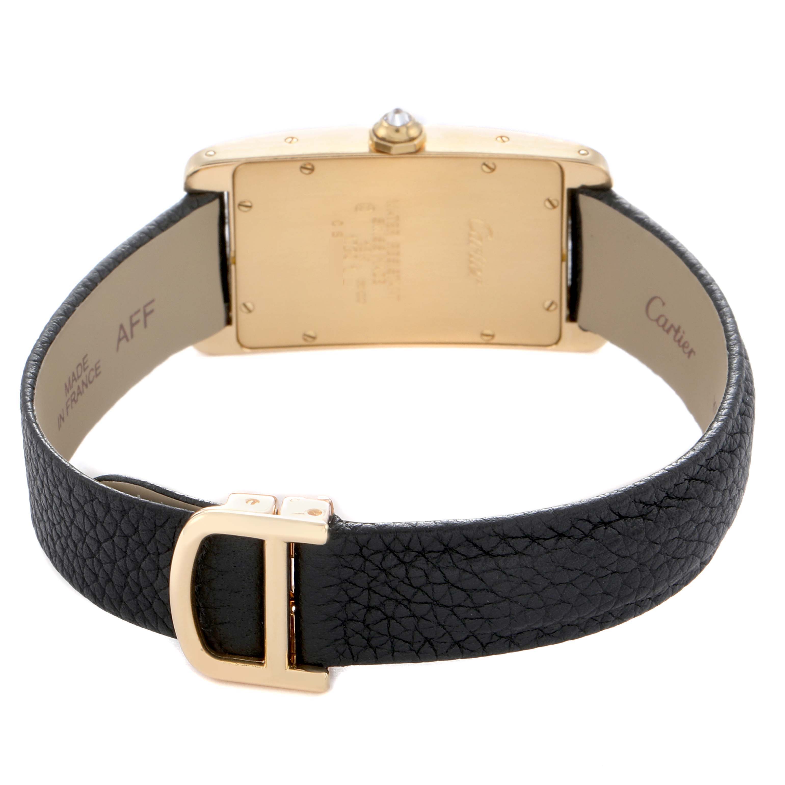 The image shows the back of the Cartier Tank Americaine 17201 Men
s Yellow Gold Silver Dial 17201 Men
s Yellow Gold Silver Dial watch, including the case back, black leather strap, and clasp.