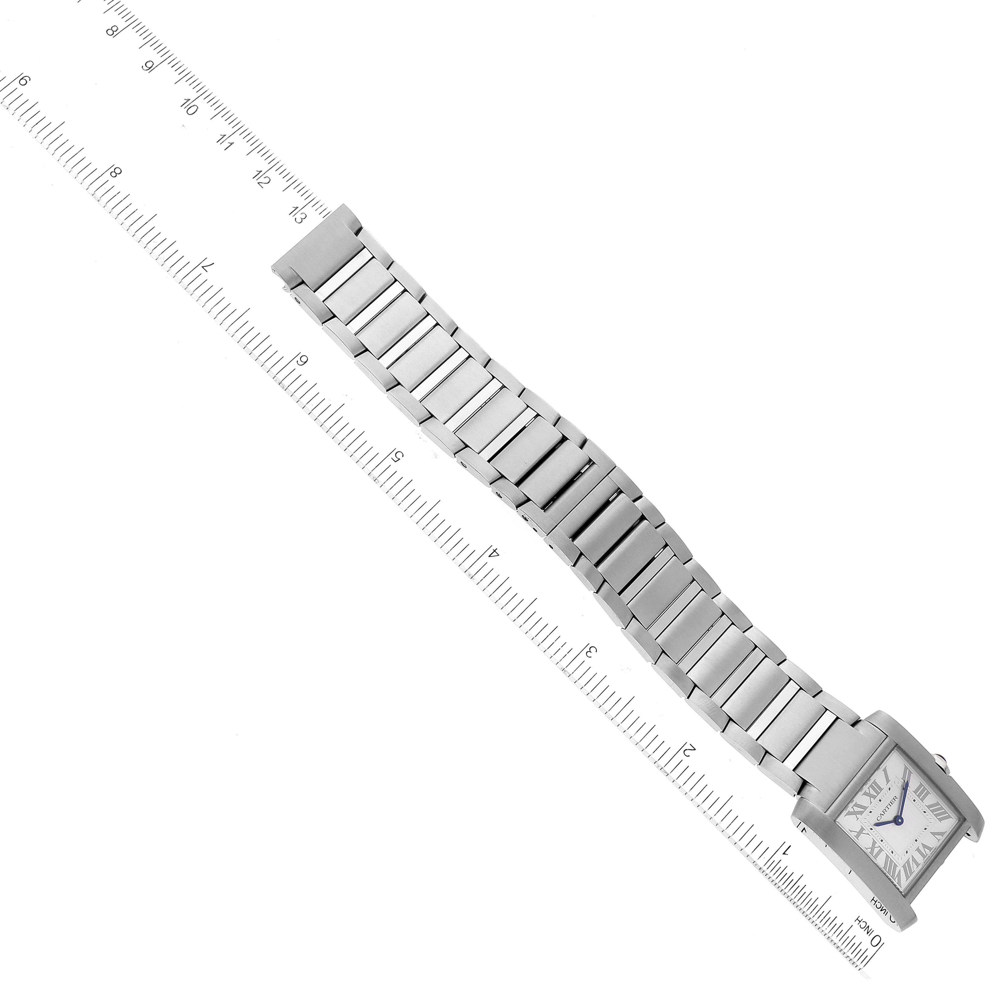 The Cartier Tank Française watch is shown from an angled top-down view, displaying the face and full bracelet against a ruler for scale.