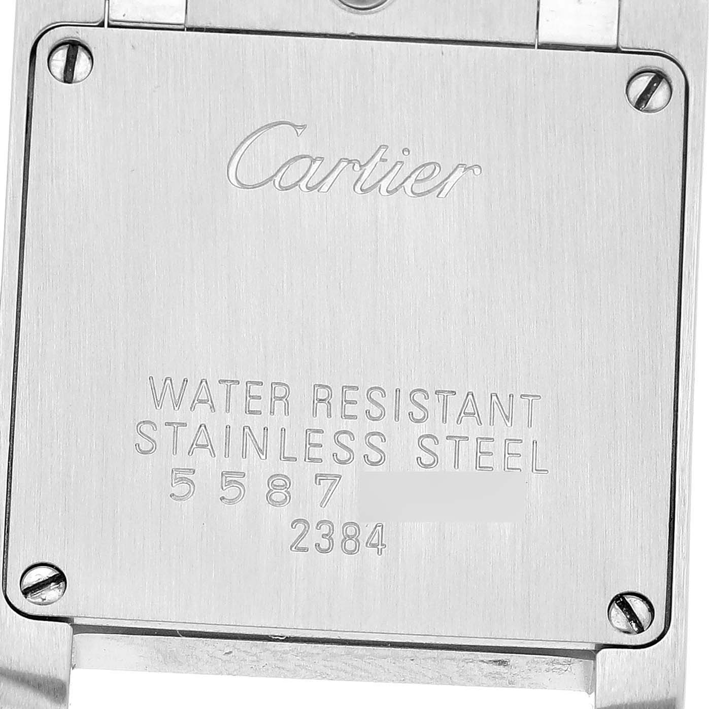 The image shows the back plate of the Cartier Tank Francaise W51027Q4 Women's Steel and Gold (two tone) Mother of Pearl Dial watch with engraved details.