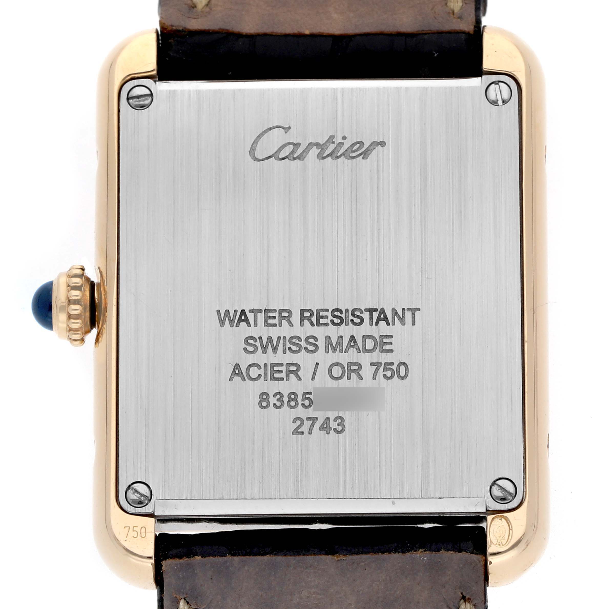 The image shows the back of a Cartier Tank Solo W1018755 Women
s Steel and Gold (two tone) Silver Dial W1018755 Women
s Steel and Gold (two tone) Silver Dial watch, highlighting the metal case, screws, and crown with a blue cabochon.