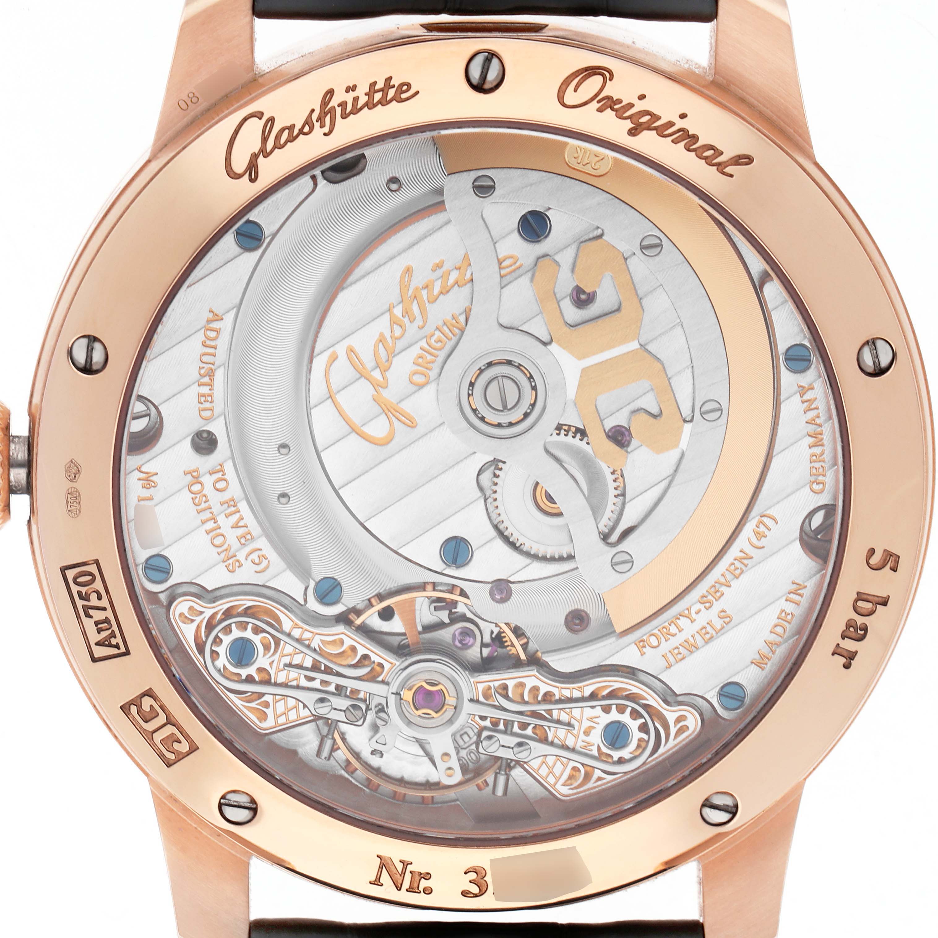 The image shows the back view of a Glashütte Pano model watch, highlighting its intricate movement and inscriptions.