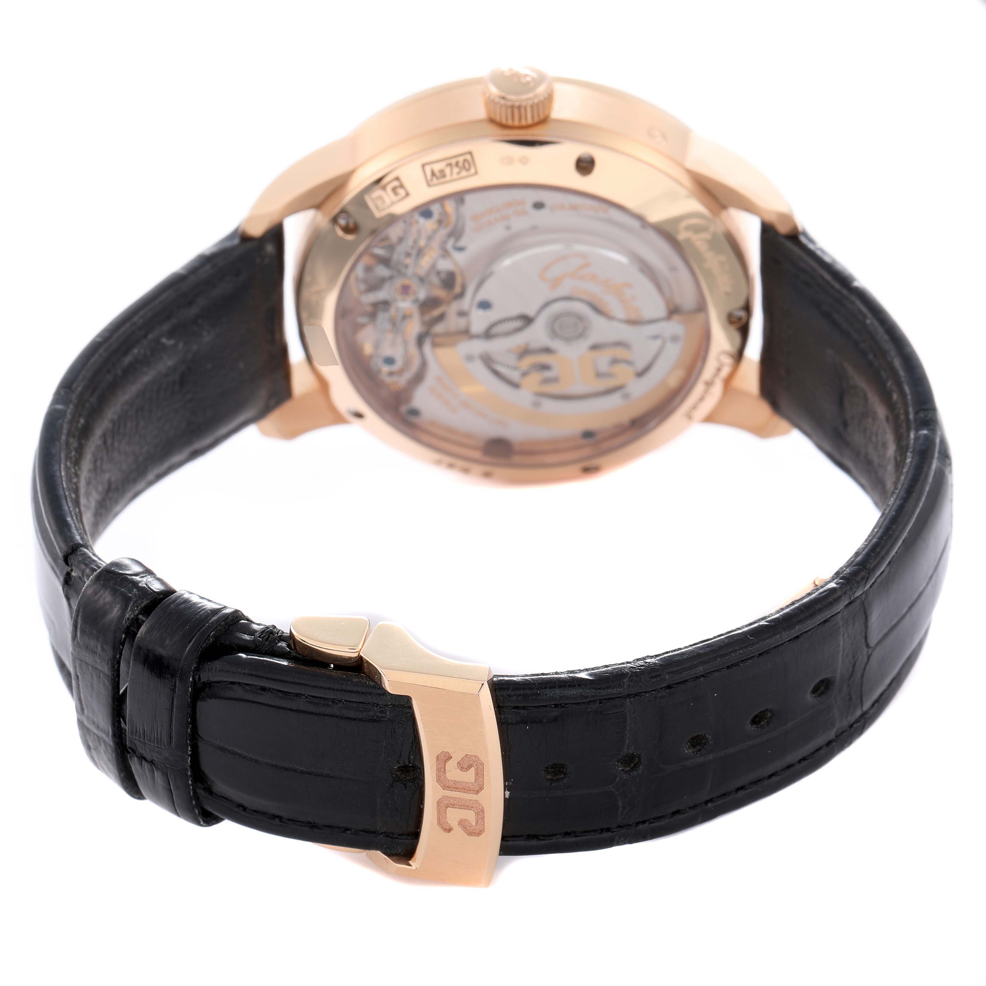 The image shows the back view of a Glashütte Pano watch, highlighting its movement through a transparent case back and a black leather strap with a clasp.