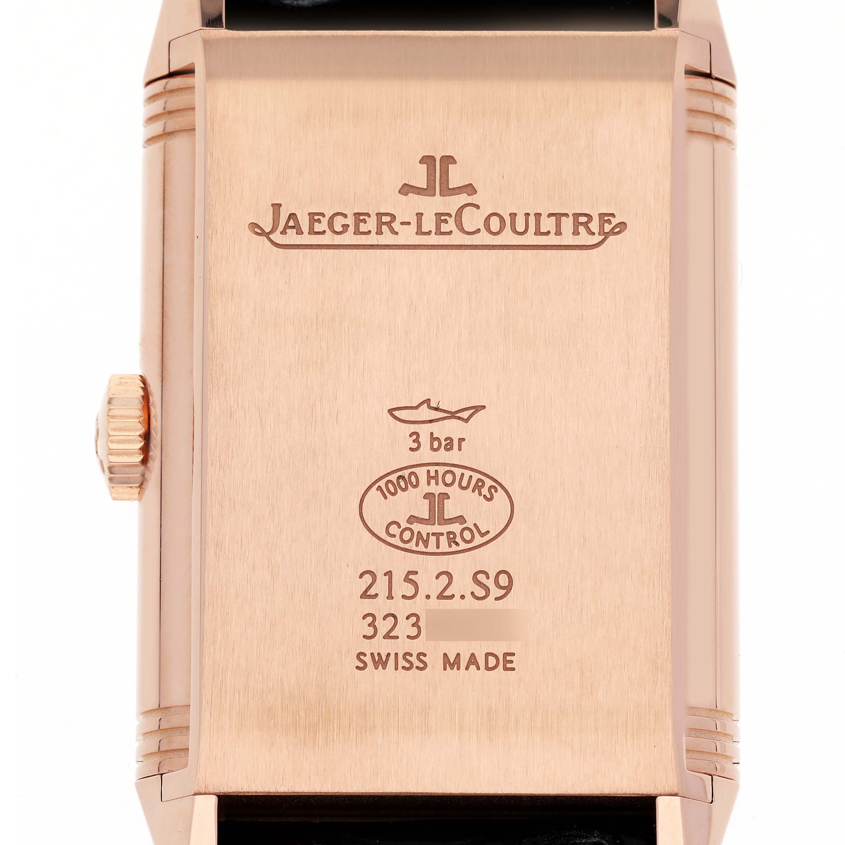 The image shows the back of a Jaeger-LeCoultre Reverso watch, displaying the brand logo and technical details.