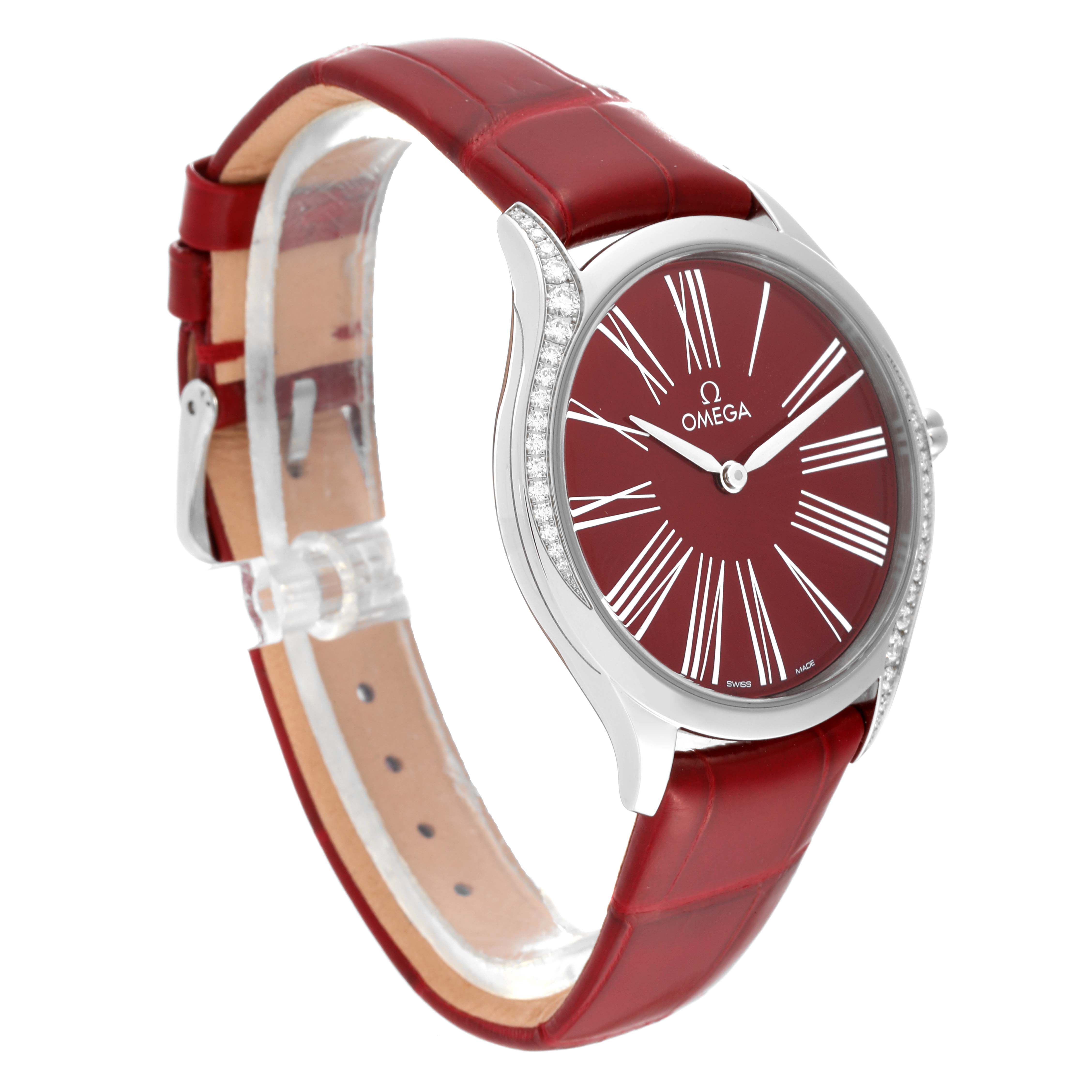 The Omega 428.18.36.60.11.002 Women's Stainless Steel Red Dial 428.18.36.60.11.002 Women's Stainless Steel Red Dial DeVille Tresor Diamond Red Dial Ladies Watch 428.18.36.60.11.002 is shown at a 3/4 angle, highlighting the red dial, diamond bezel, and red strap.