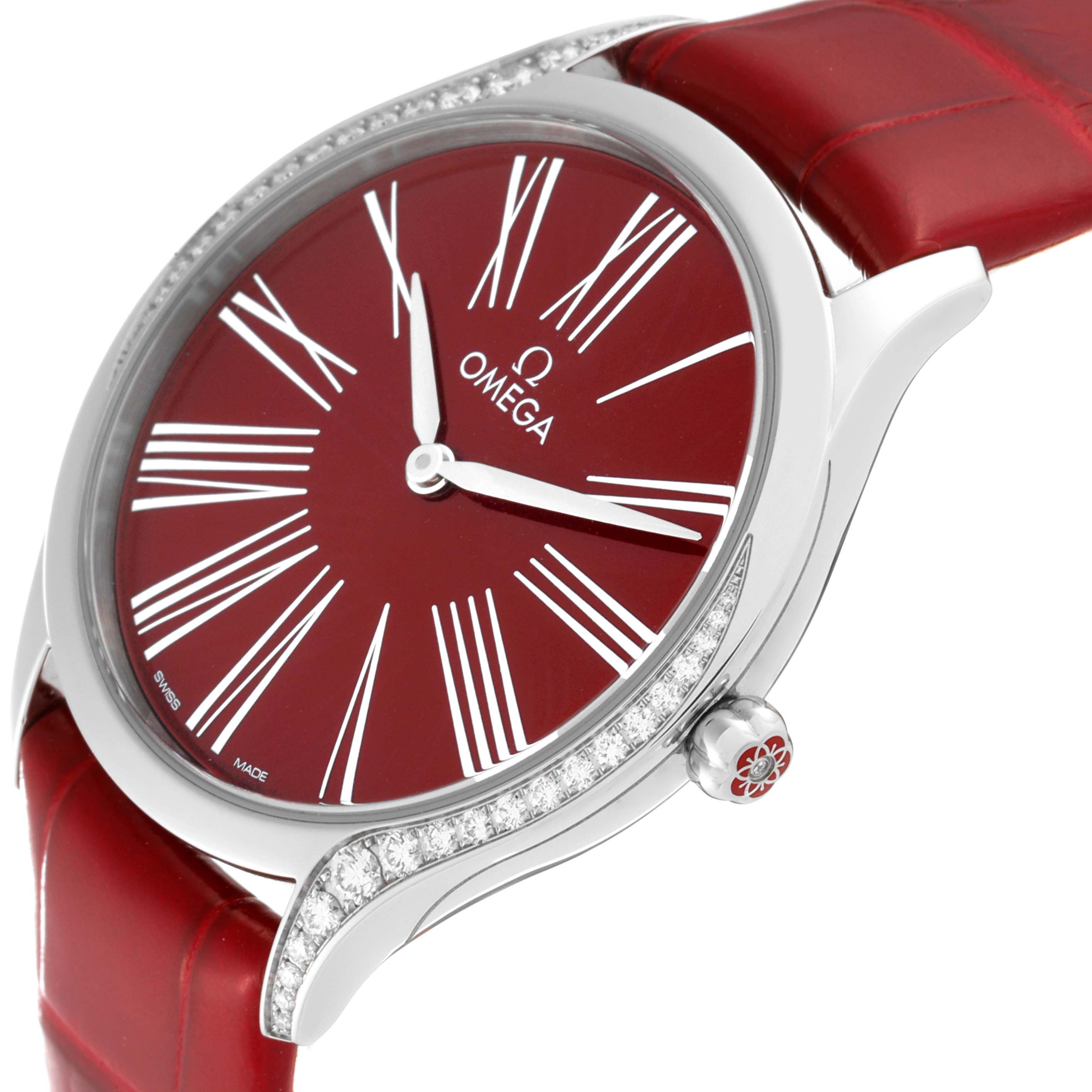 This image shows the Omega 428.18.36.60.11.002 Women's Stainless Steel Red Dial 428.18.36.60.11.002 Women's Stainless Steel Red Dial DeVille Tresor Diamond Red Dial Ladies Watch model 428.18.36.60.11.002 from a side angle, highlighting its face, bezel, and strap.