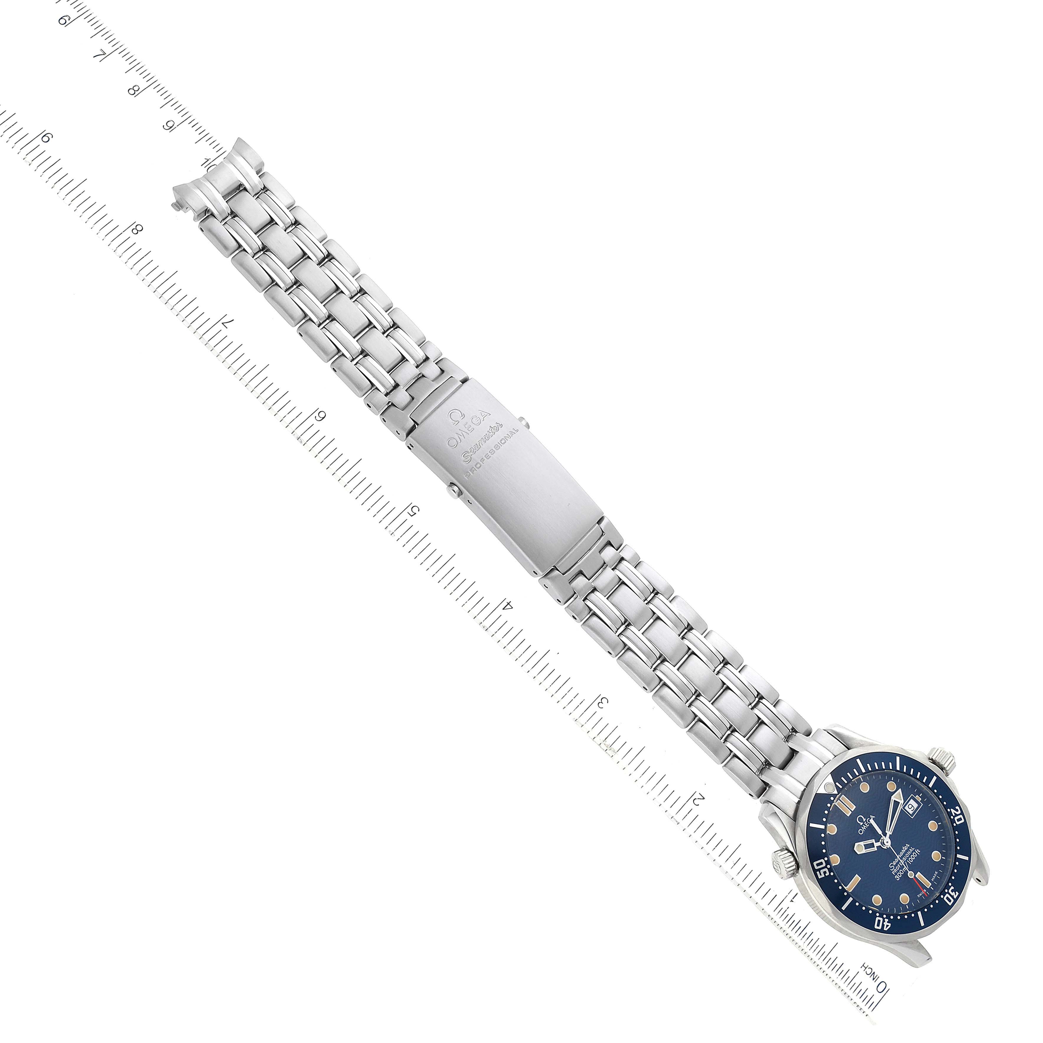 The image shows an overhead view of the Omega Seamaster 2561.80.00 Men
s Stainless Steel Blue Dial 2561.80.00 Men
s Stainless Steel Blue Dial watch, featuring its bracelet and clasp aligned with a measuring scale.