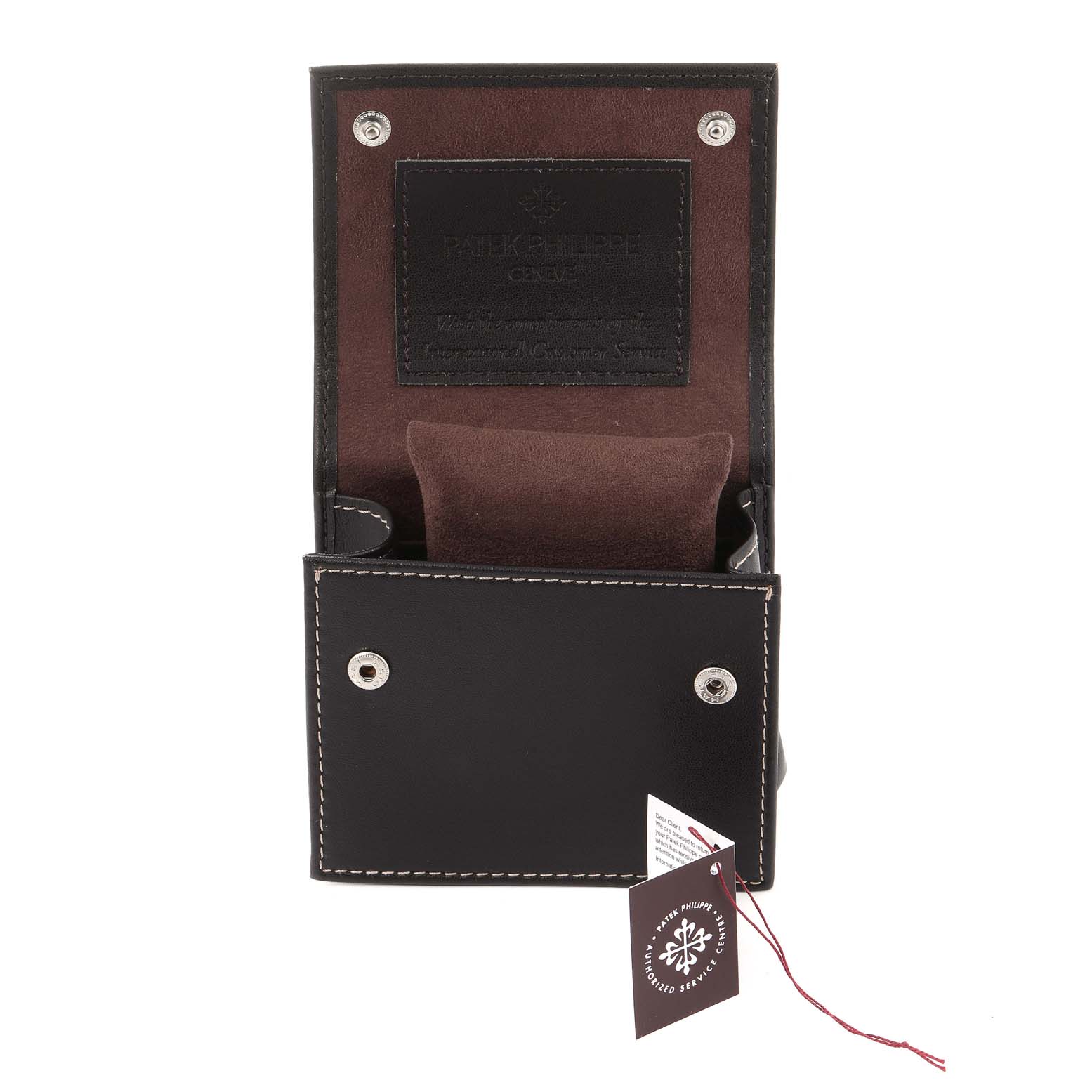 The image shows an open Patek Philippe Calatrava 5026J Men's Yellow Gold Black Dial 5026J Men's Yellow Gold Black Dial watch case, displaying stitching details and a tag.