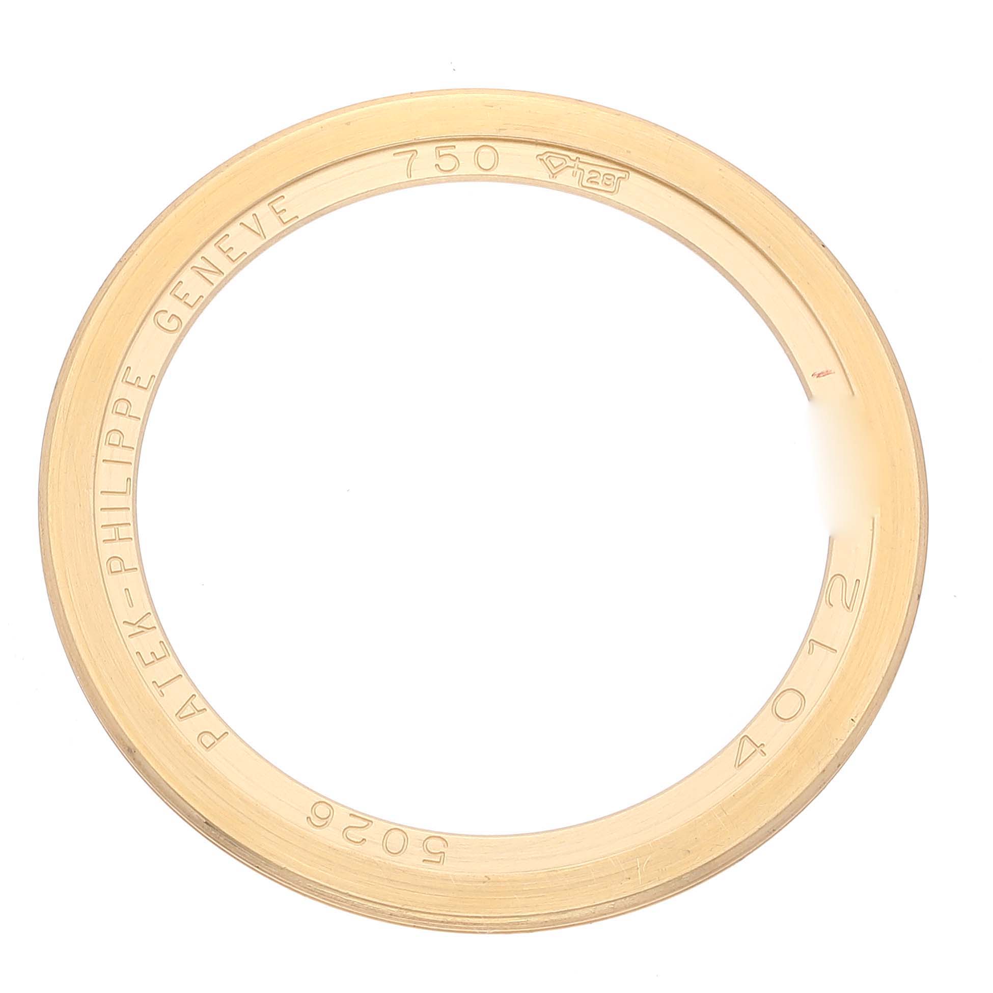 This image shows a gold bezel ring for a Calatrava model by Patek Philippe, captured from a top-down angle.